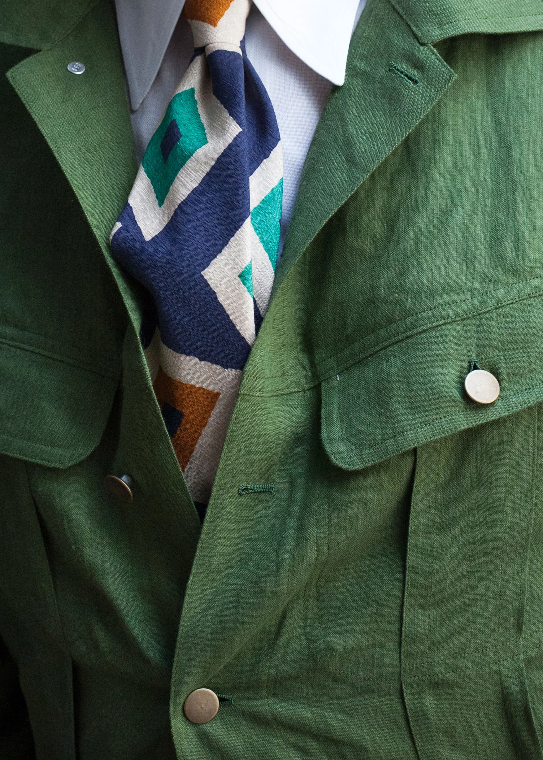 The rough texture, large pattern, and bright colors of this playful silk/cotton tie complements the casual vibe of Alan’s bespoke linen trucker jacket.