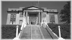 They fly to Pawhuska and land behind the courthouse.