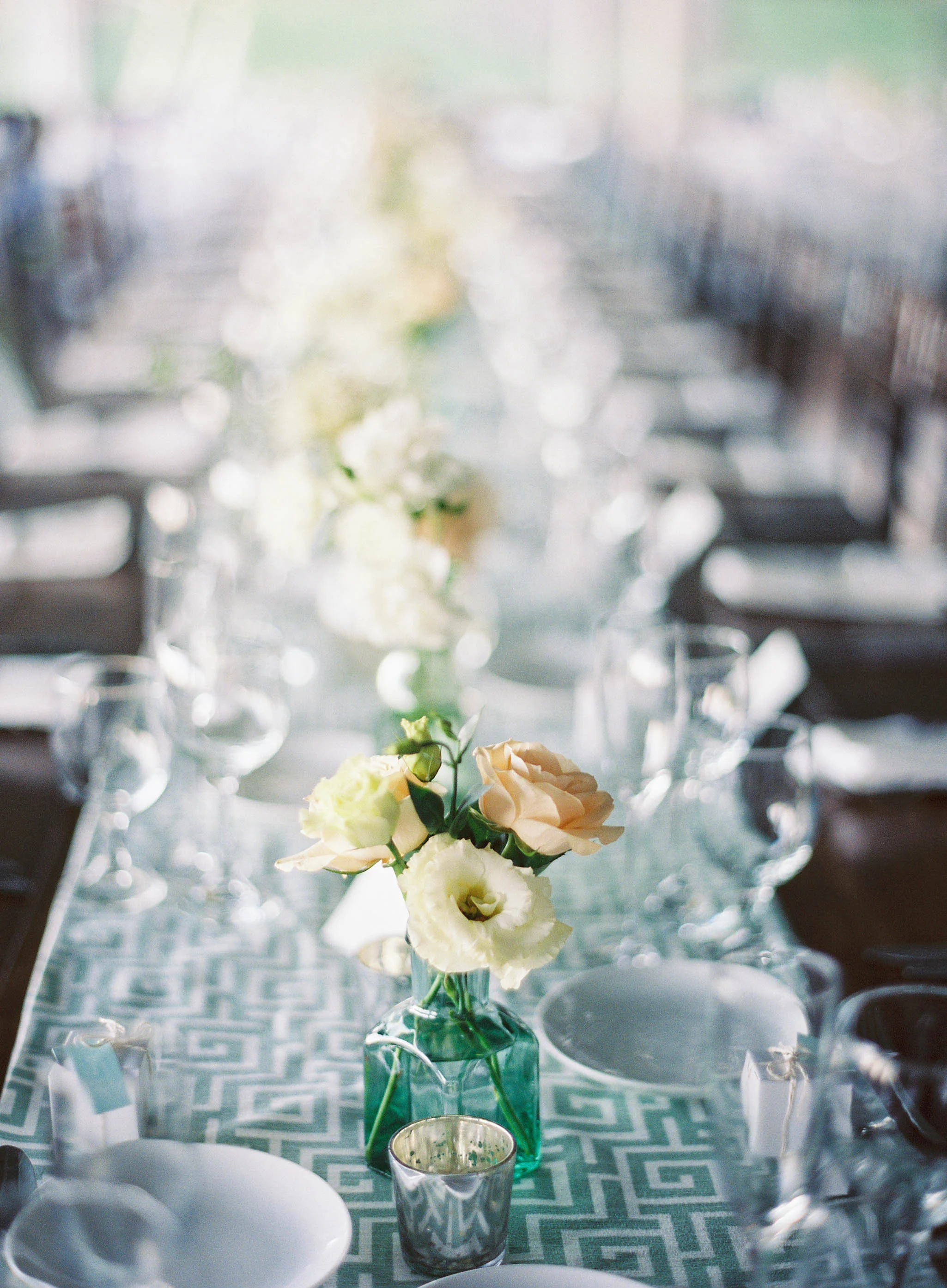 Bottle bud vases on farm tables