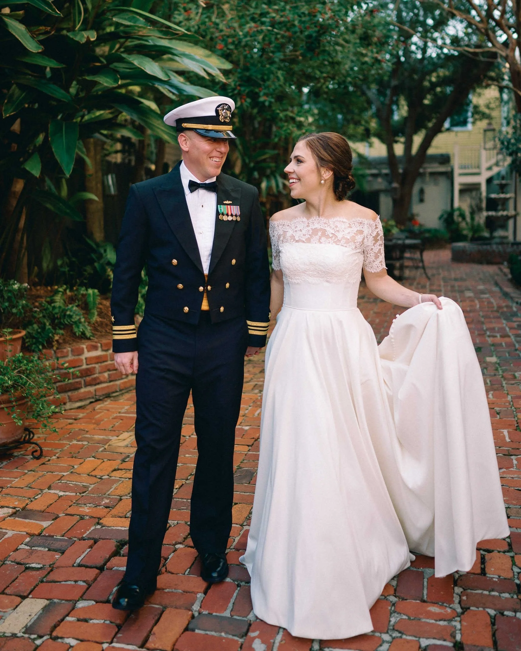 navy-officer-groom-bride-courtyard-terrell-house-new-orleans.jpg