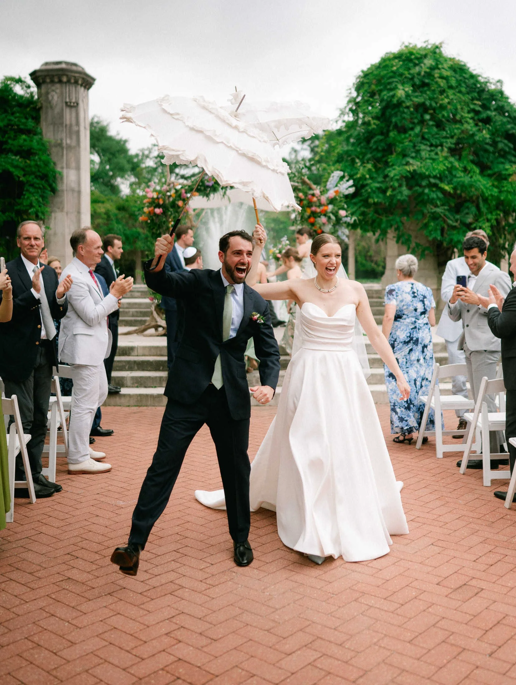 bride-groom-recessional-popp-fountain-parasols-new-orleans-wedding.jpg