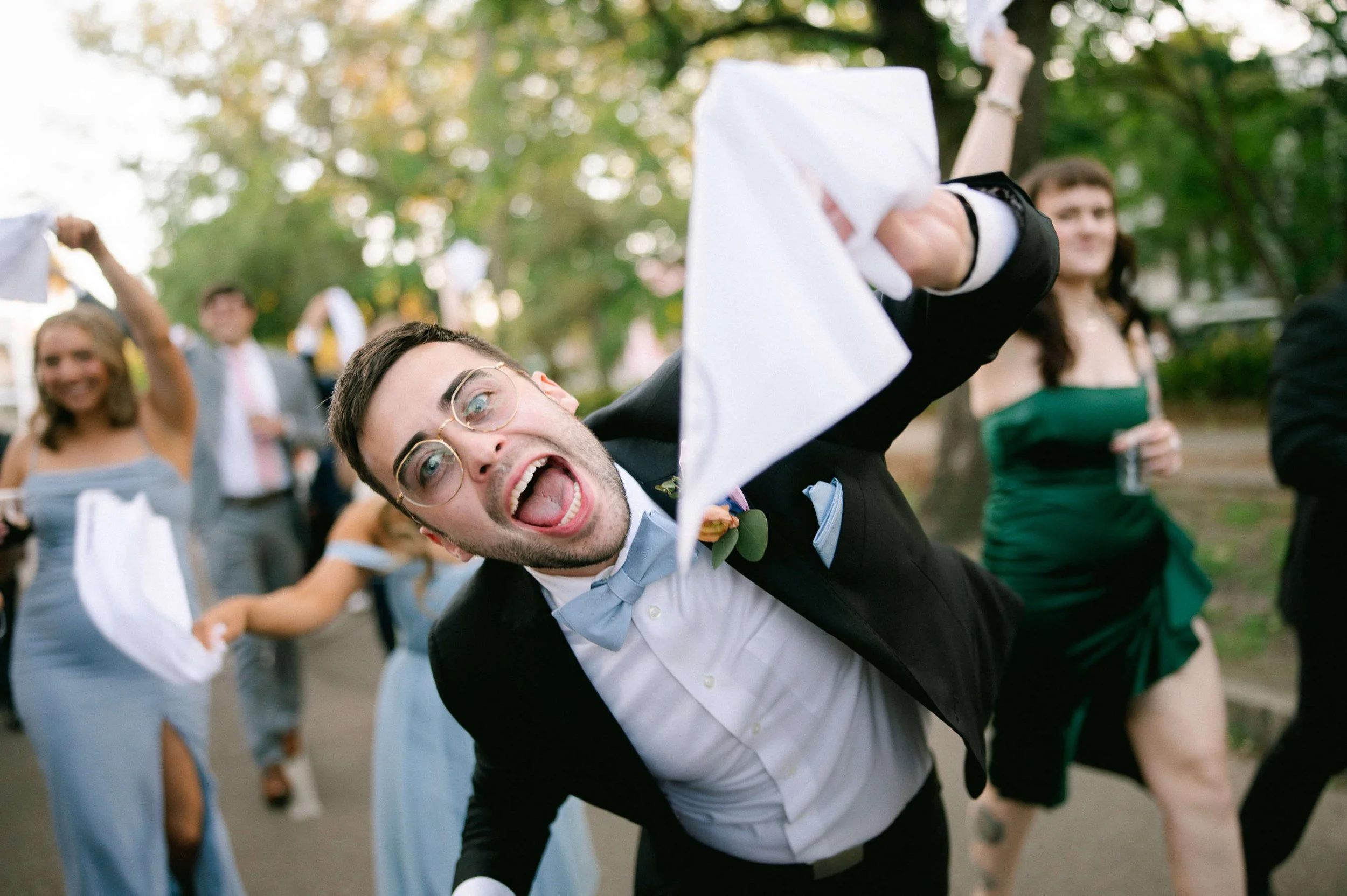 second-line-guest-waving-handkerchief-lower-garden-district-new-orleans-wedding.jpg