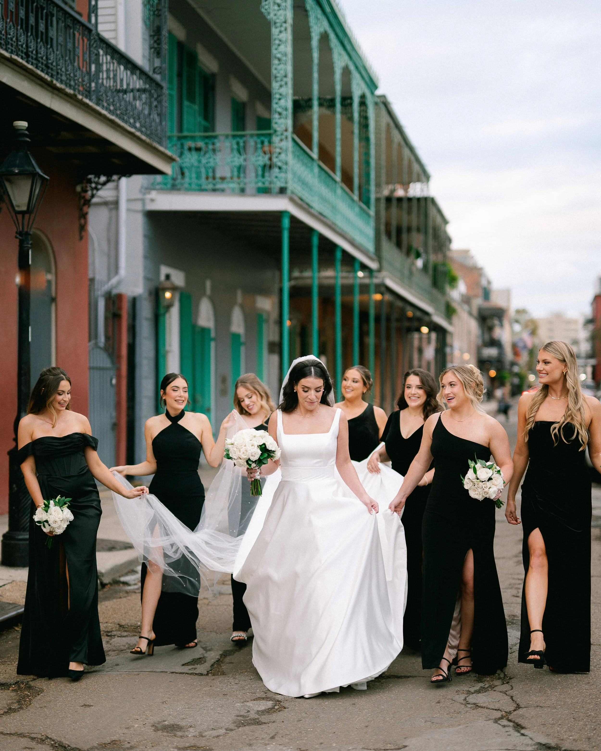 Bride and her wedding party walking through the streets of the French Quarter in New Orleans