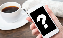 A hand holding a smartphone with a question mark on the screen.