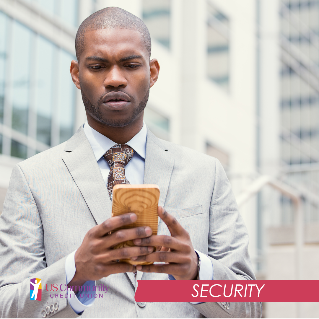 A concerned business man looking at his smartphone