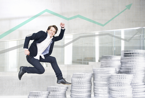 man jumping over giant coins