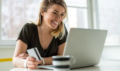 Woman+Making+a+payment+using+card+on+a+laptop.jpg