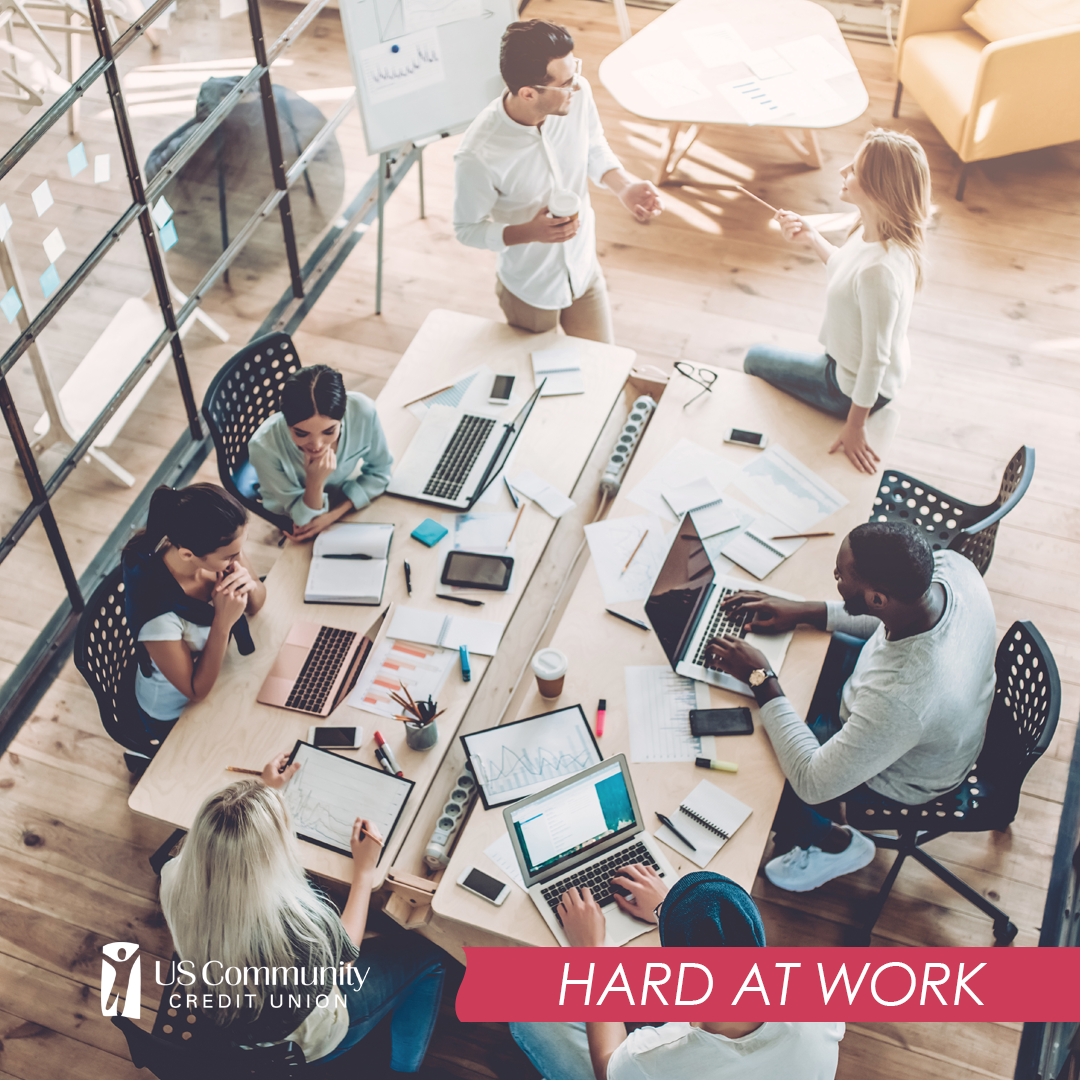 Group of seven people working around a table.