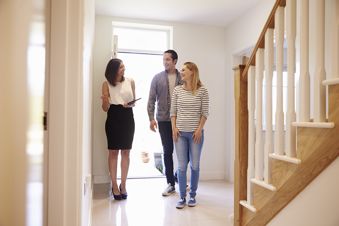 A realtor showing the interior walkway of a house