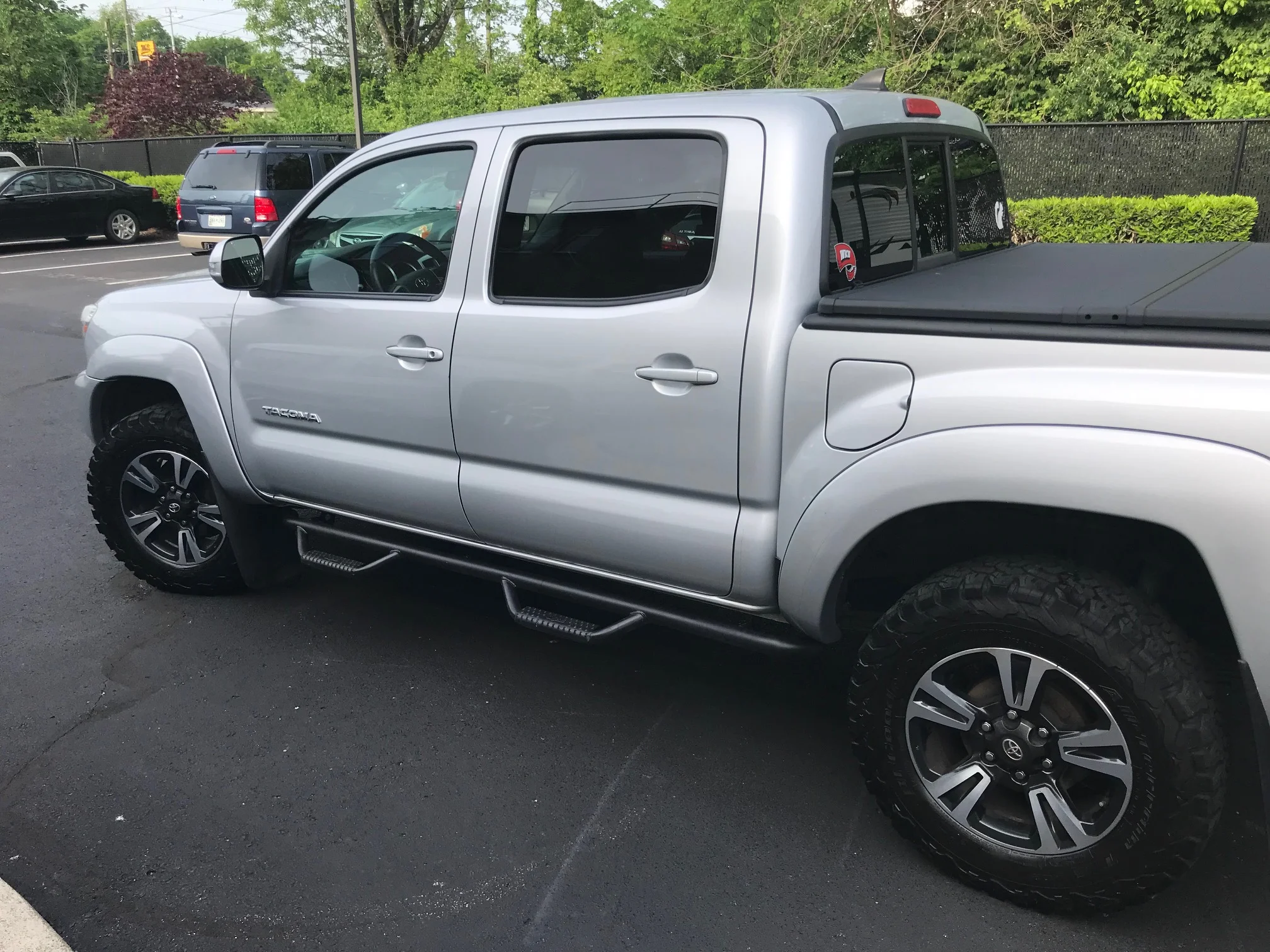 Side exterior view, showing 2 doors, tires, and a covered truck bed