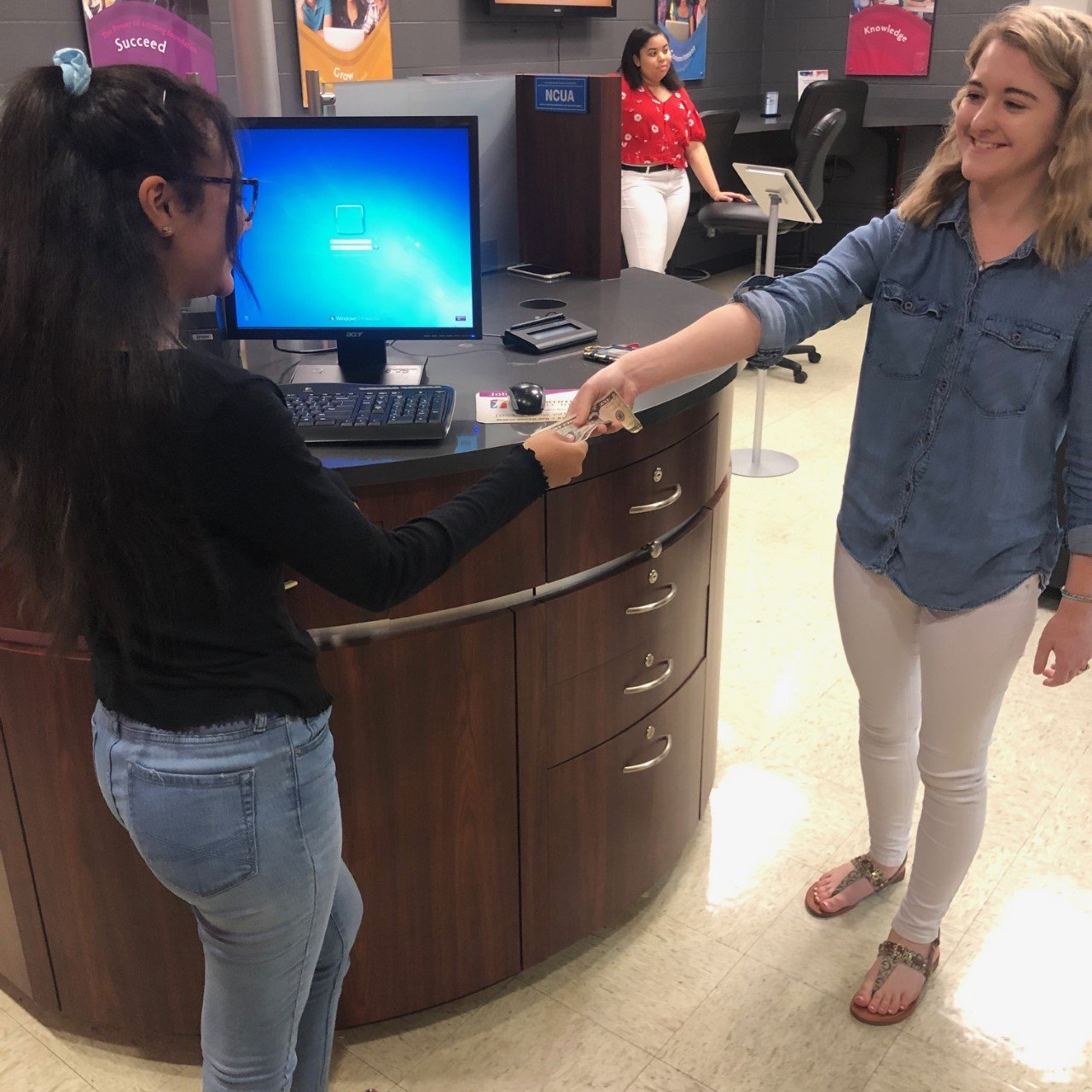 Student teller at the McGavock High School Branch conducting a transaction for a member.