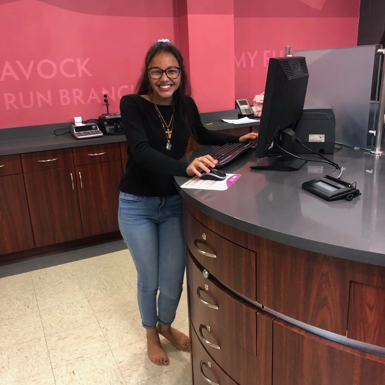McGavock High School Student Employee standing at the teller station.