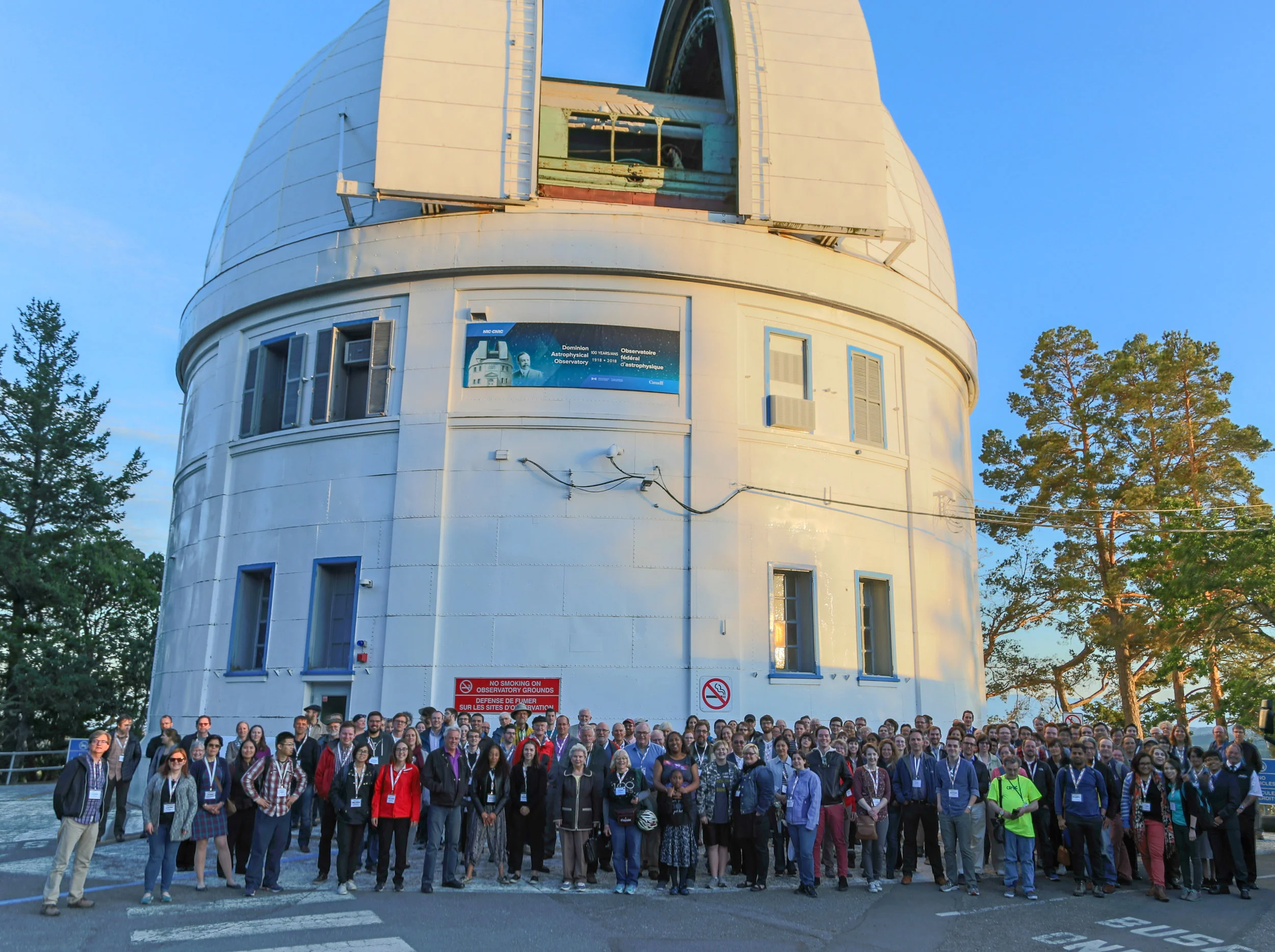 Canadian astronomers met in late May to celebrate the anniversary of first light at the Plaskett Telescope. Here they are pictured just outside the building that houses the telescope. Photo is by Victoria photographer Joe Carr.