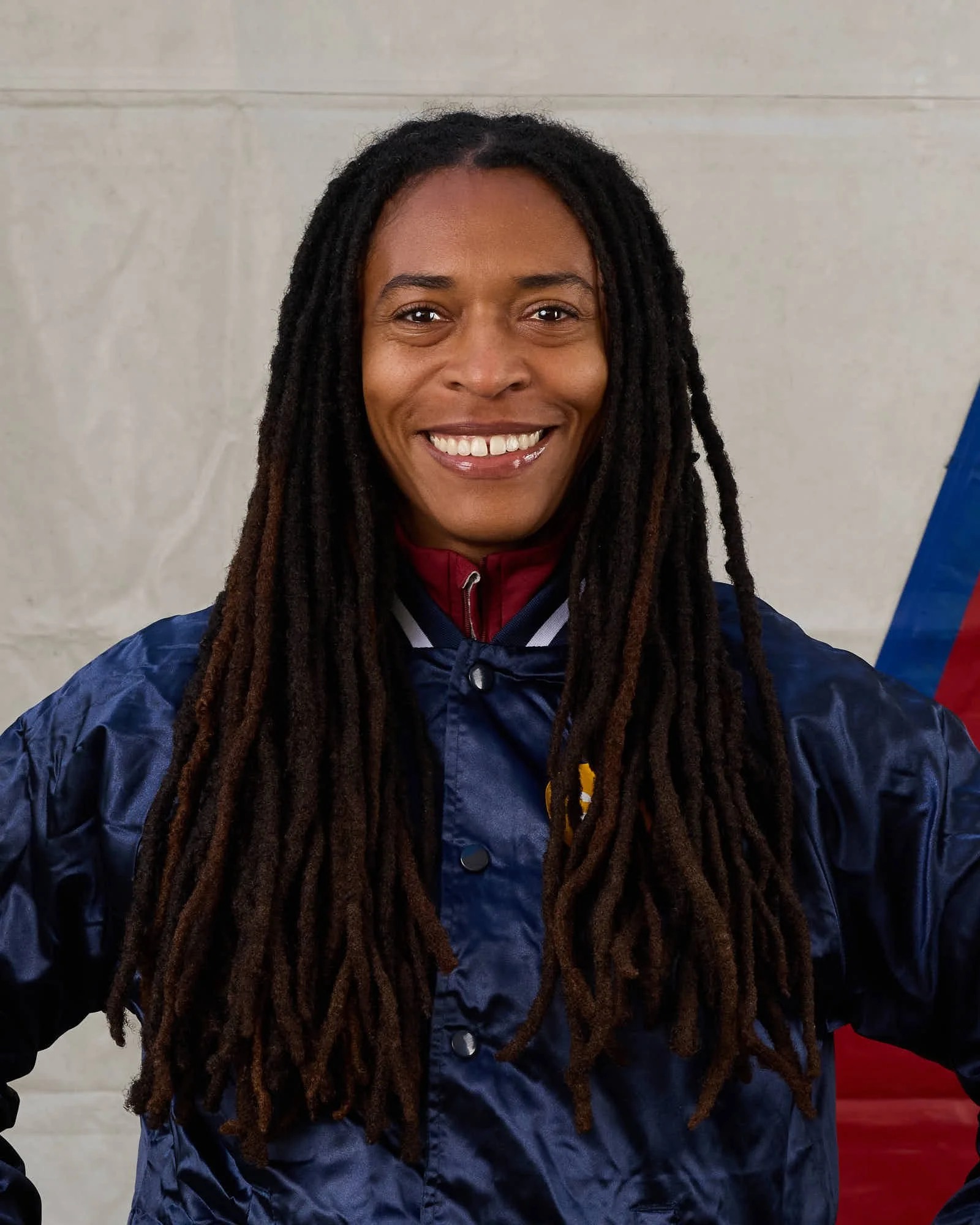 Violinist Christina Walton smiling with long dreadlocks.
