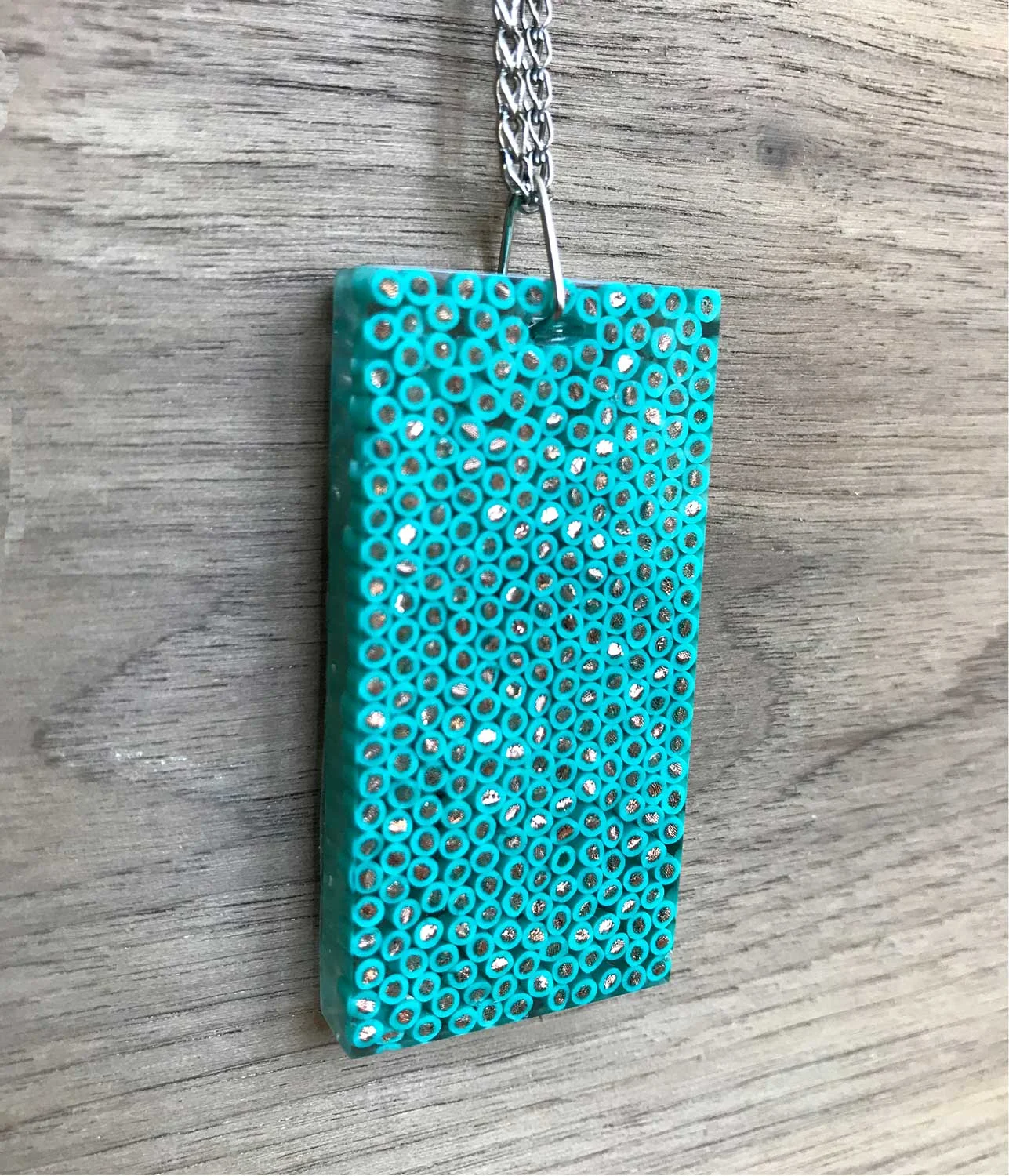 Resin pendant made of recycled wire. Side view