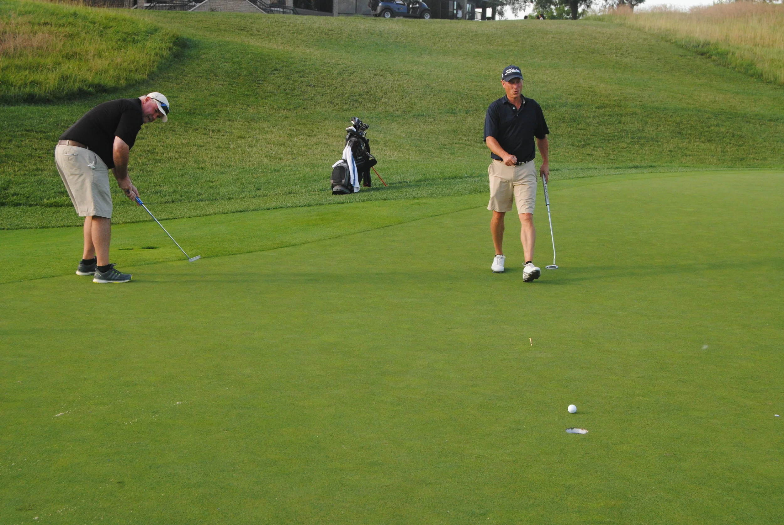 Richard leaves his putt just short of the cup on the 18th green