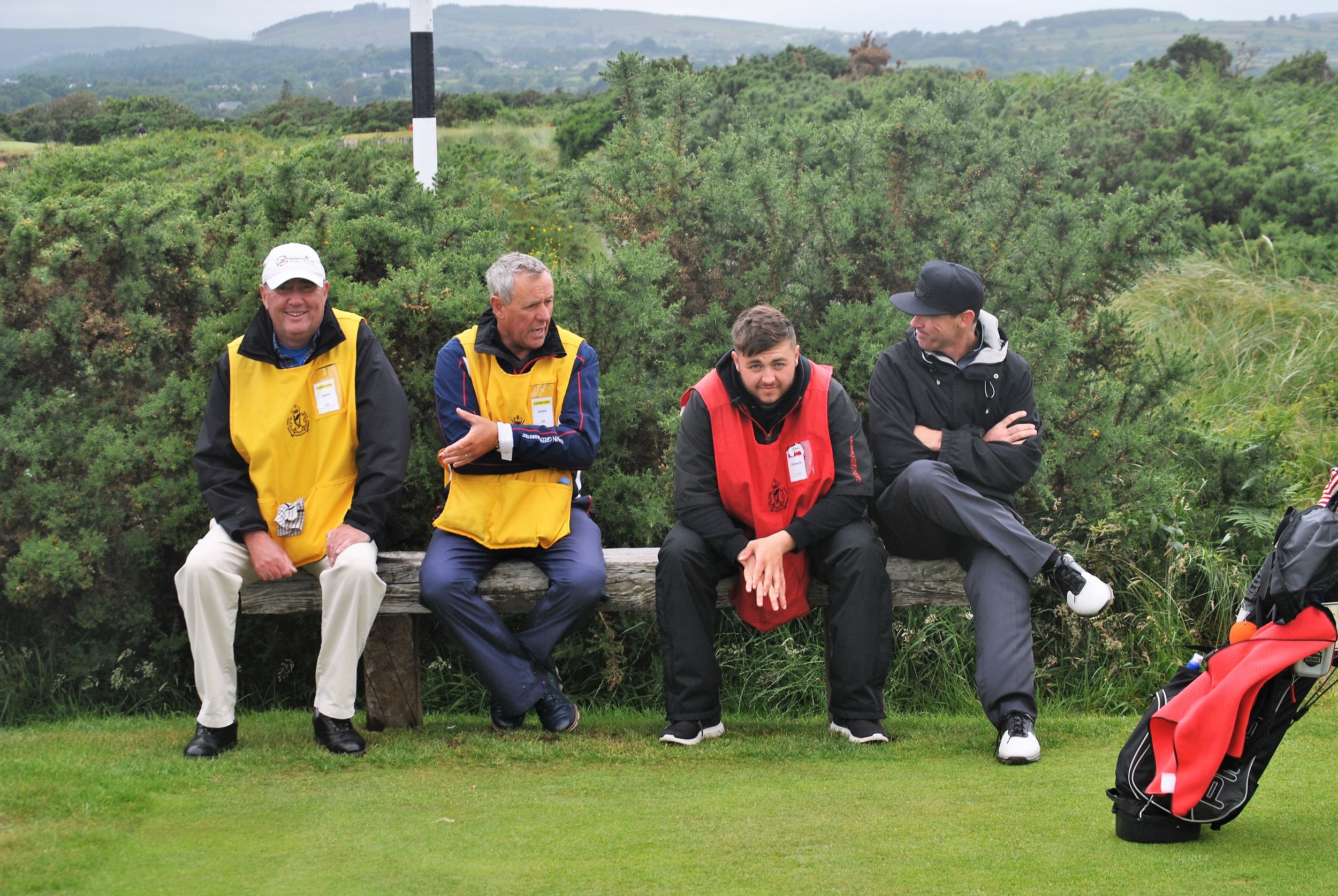 The caddies and Chad take a break while we wait to tee off on the Par 3 14th hole