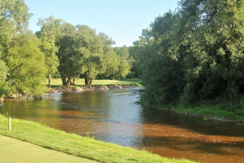 The scenic but difficult par 3 thirteenth hole. Requires a 200 yard high draw to clear the trees and land on the green.