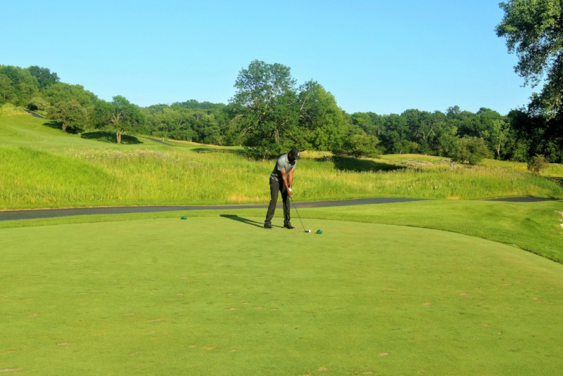Hitting a provisional with my 5 hybrid on the 13th hole. I hit a high draw that cleared the trees and landed on the green. It didn't matter since I found my first ball.