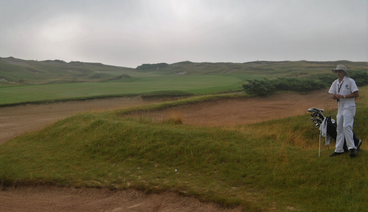 Joe C surveys the situation after my drive ended up on the edge of the bunker.