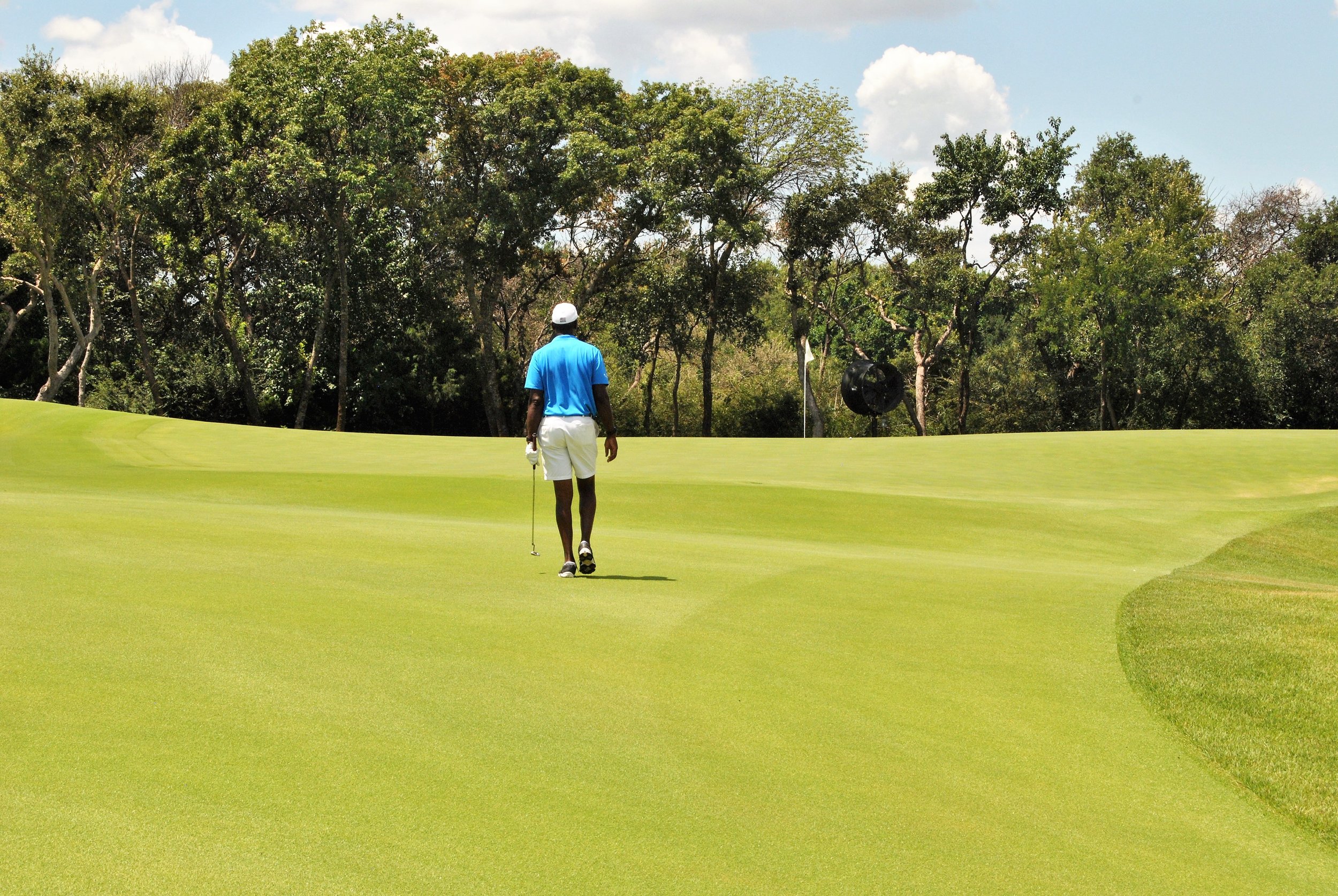Taking a nice long walk to the green after hitting my approach shot to within 8 feet of the hole.