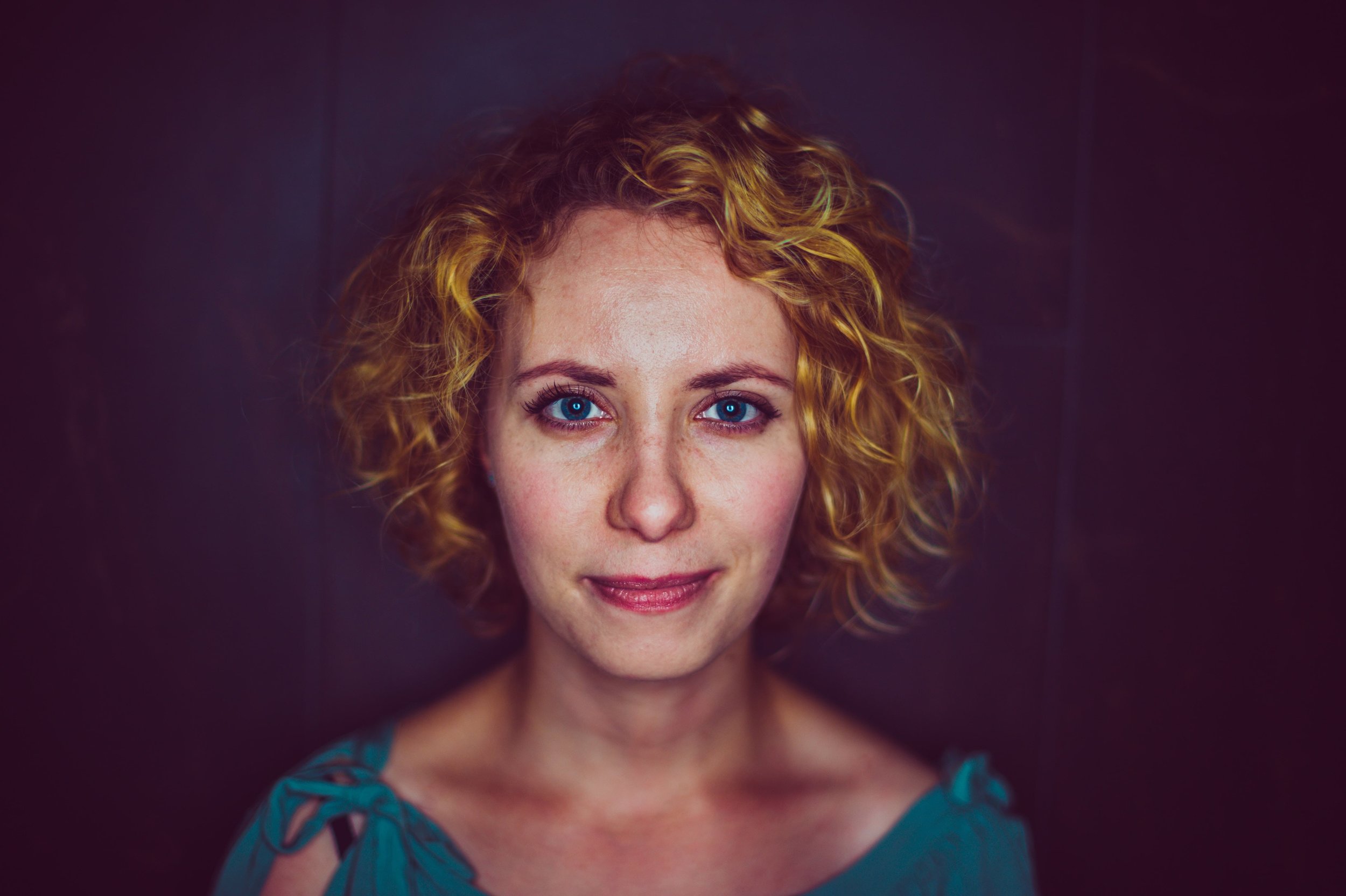 Trauma-counselling-in-Melbourne-Counselling-and-psychotherapy-for-trauma-and-Complex-trauma-Melbourne-Complex-PTSD-treatment-Melbourne-woman-with-red-hair-and-blue-top-smiling-slightly-at-viewer