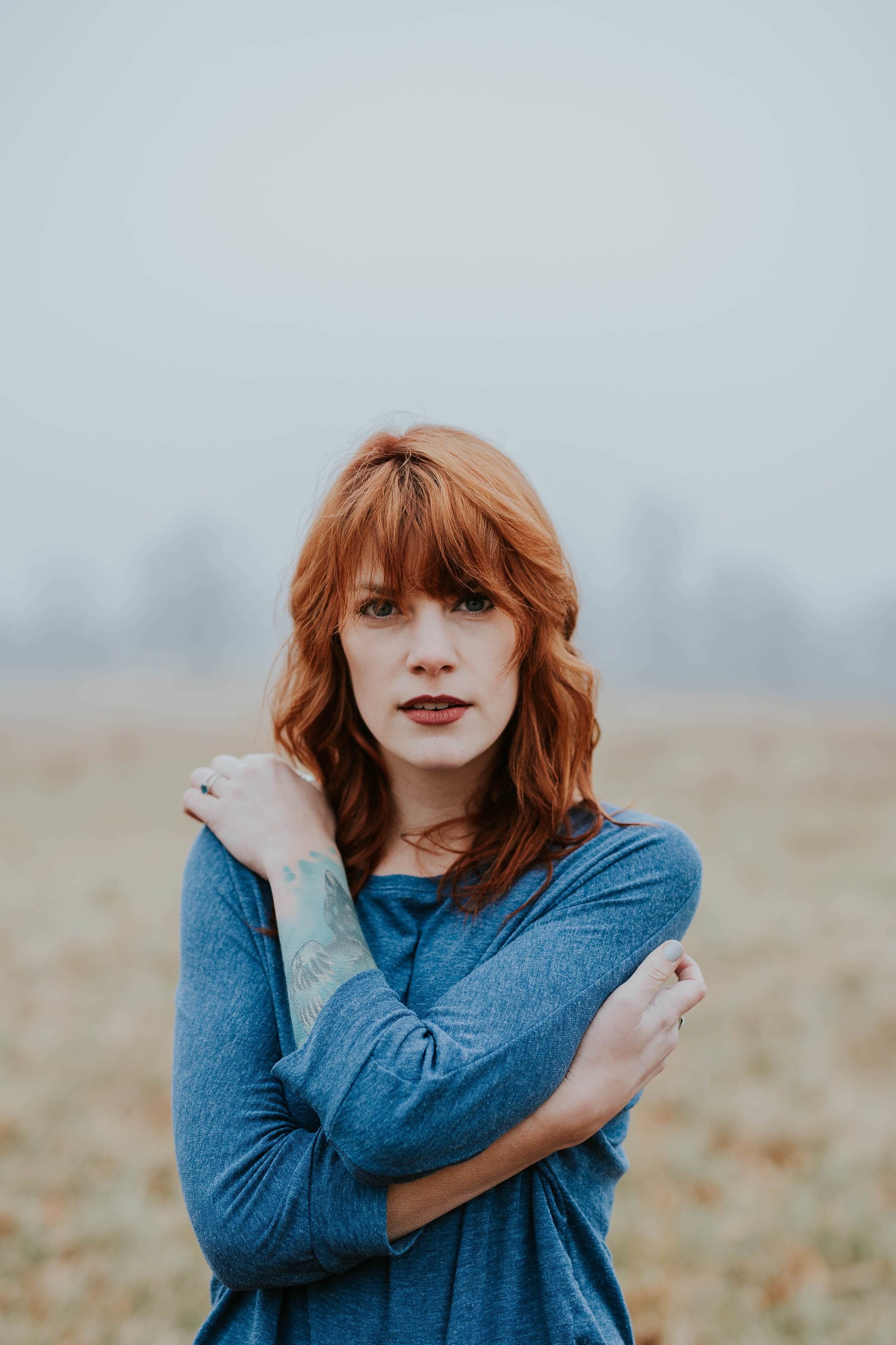 Girl-with-red-hair-wearing-blue-jumper