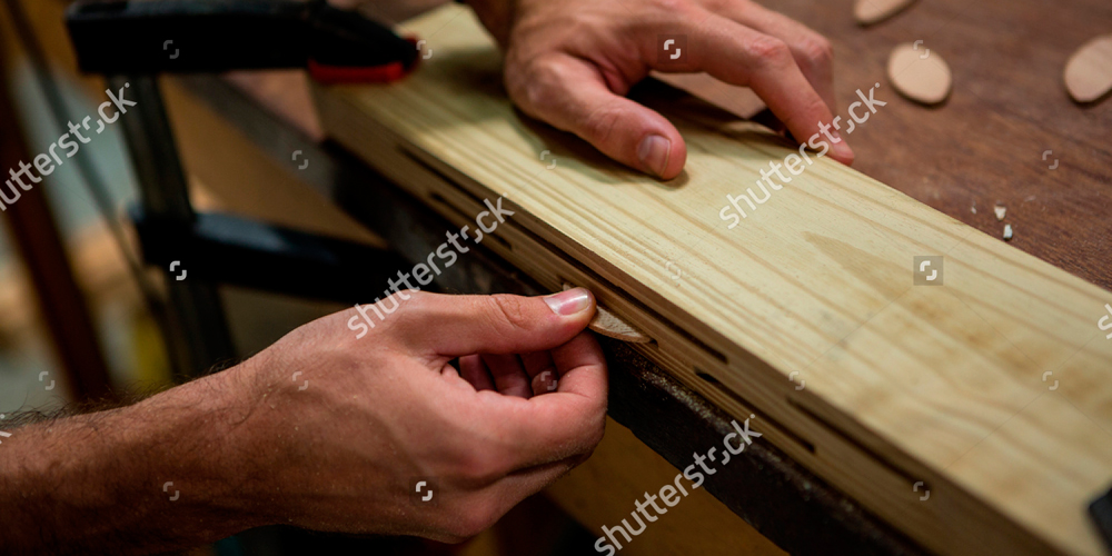 stock-photo-carpenter-working-on-his-craft-in-a-dusty-workshop-419362018-WEB.jpg