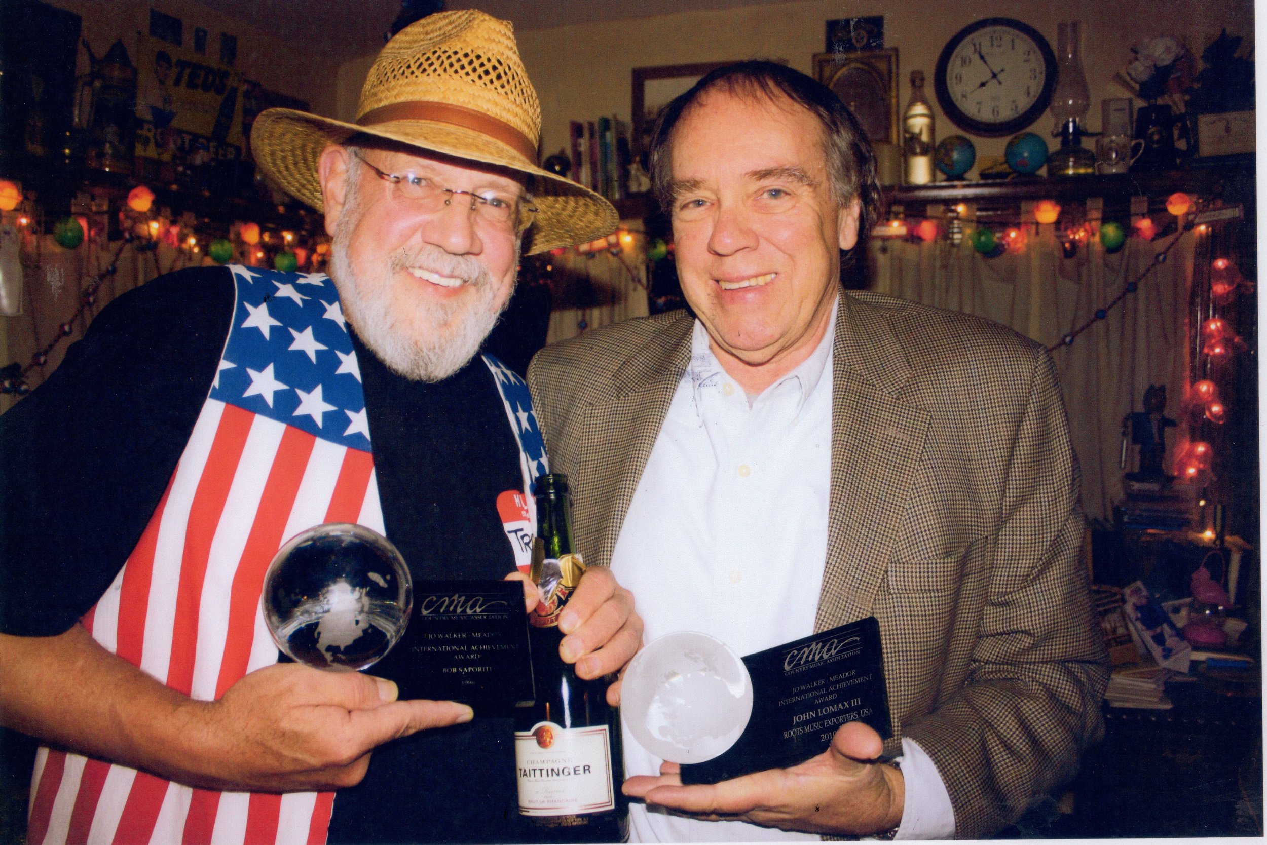 Bob Saporiti (aka Reckless Johnny Wales) and John compare their Jo Walker-Meador International Global Achievement Awards, 2010. Photo by Ryan Schemmel