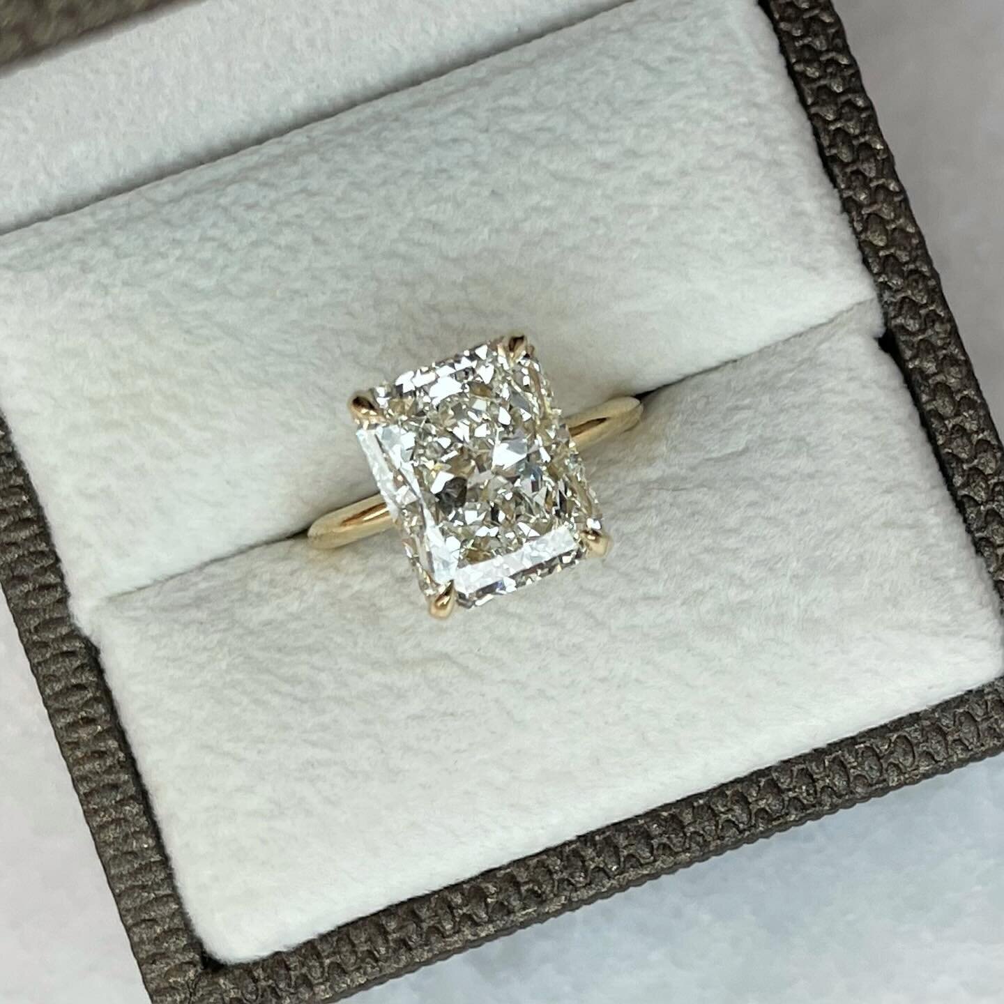 Hidden Halo ~ extra sparkle with diamond details in a classic solitaire.

5 carat, GIA certified, Natural Earth Mined Radiant Cut Diamond.  Custom design 18k yellow gold ring.