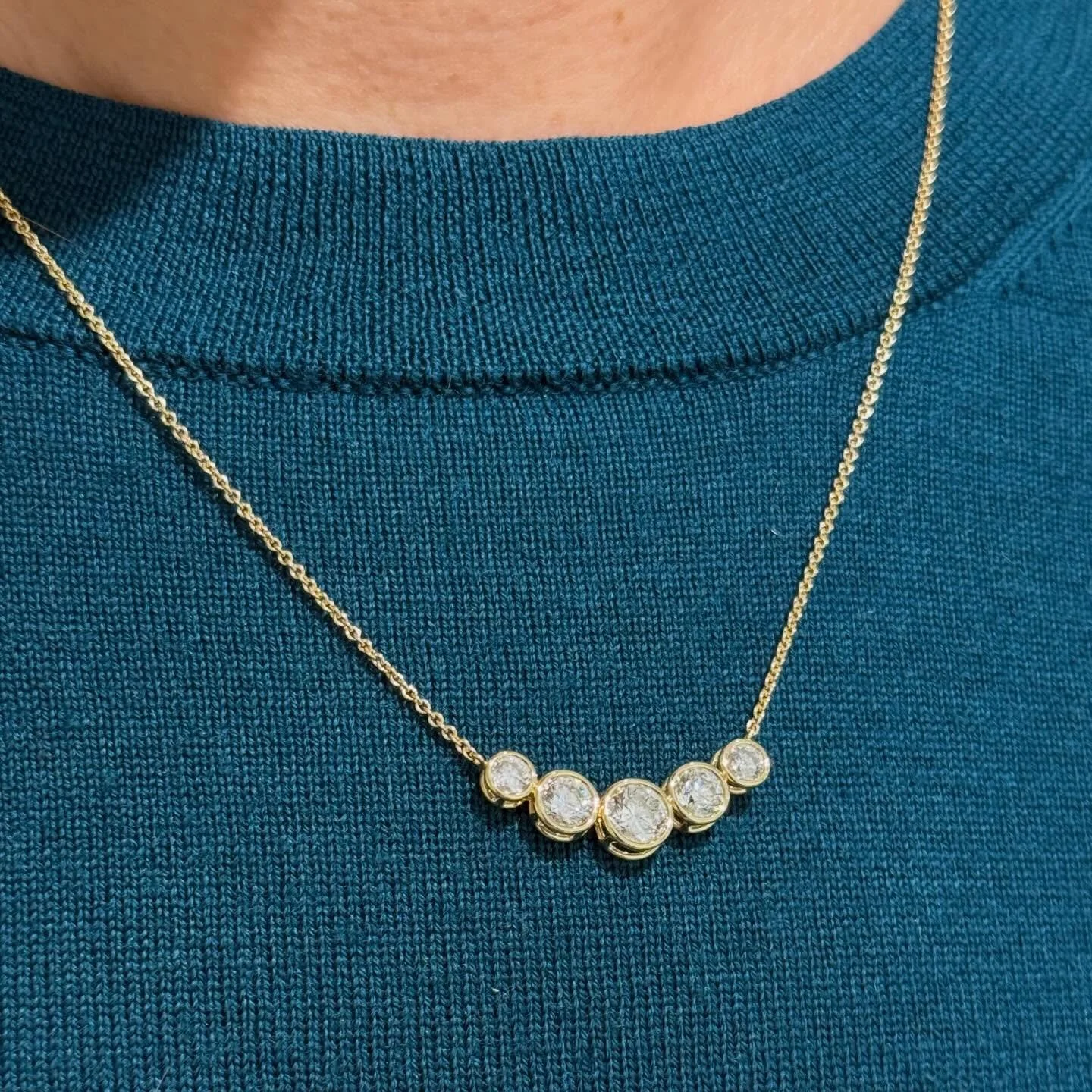 Diamonds Reimagined! 
This custom design necklace was made from a three stone ring and a pair of diamond stud earrings.  Handmade floating diamond necklace in 18k yellow gold. 
What can we reimagine and design for you?!