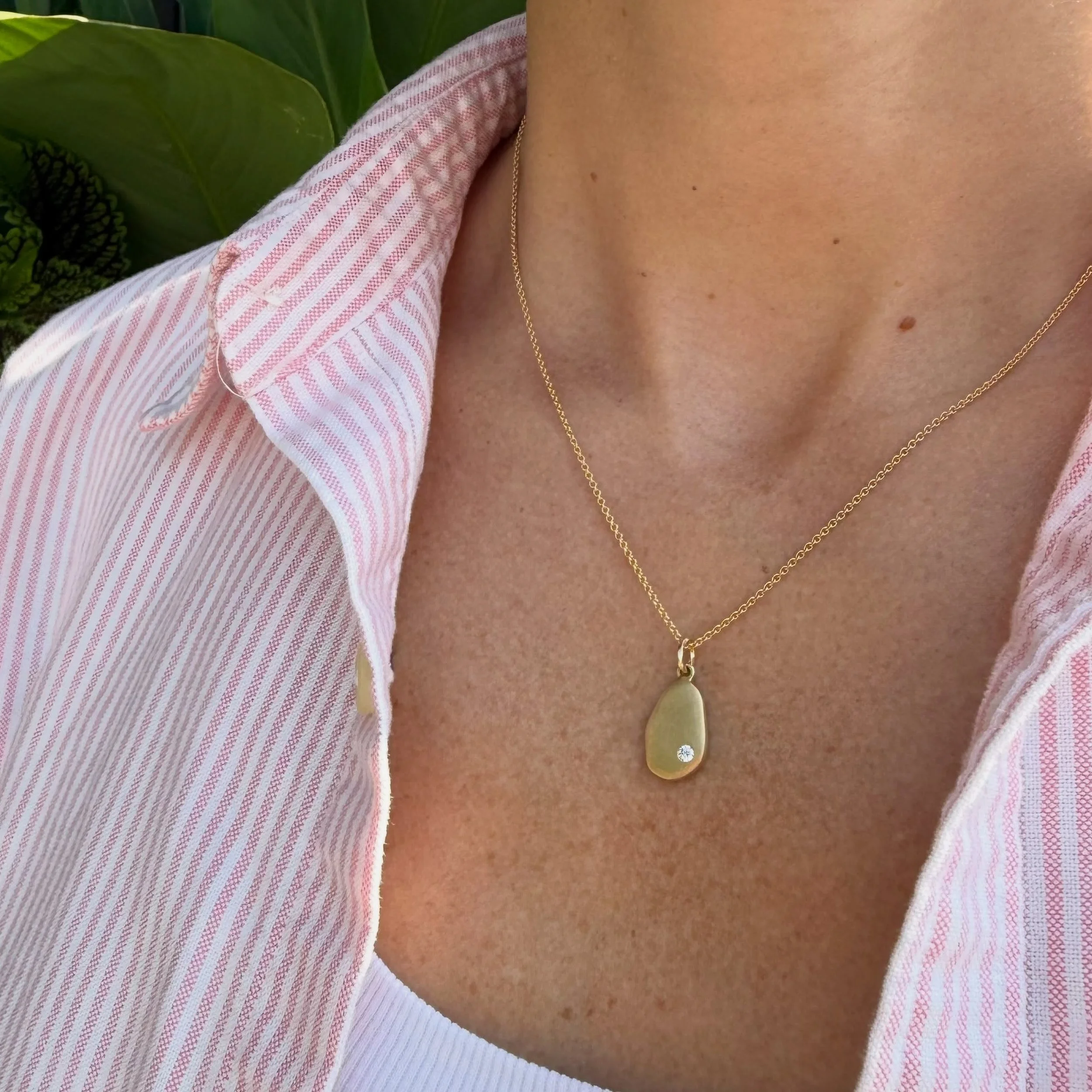 One of our favorites in the collection, our skipping stone pendant. Beautiful on its own,  and looks great layered too. Pictured with our diamond station necklace in the second photo.