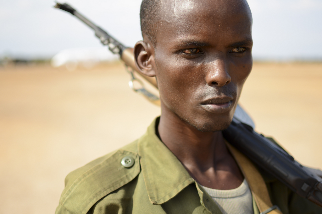 A member of the Somali National Army walks across the runway at Kismayo International Airport.