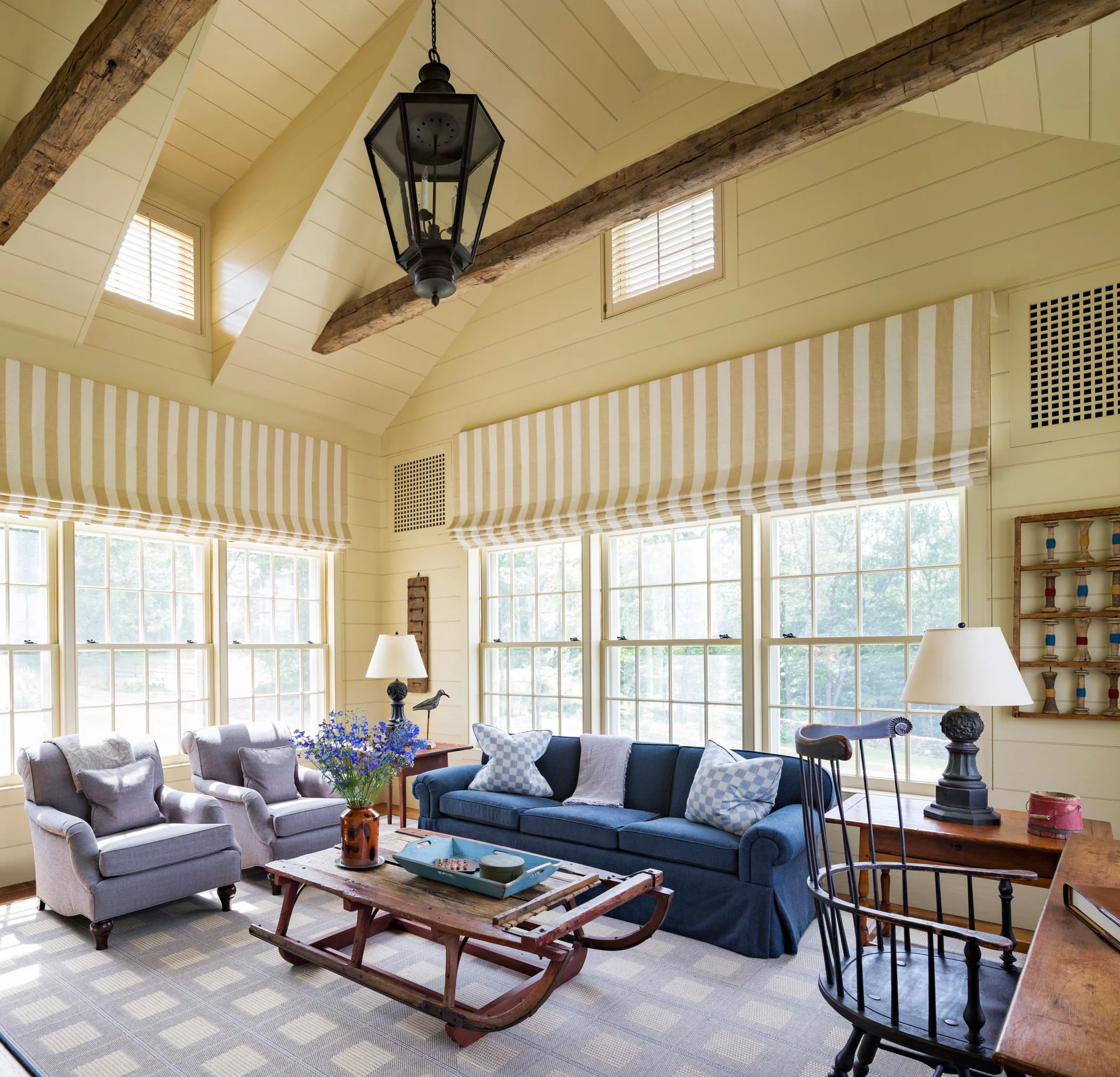 A favorite winter destination, the Sun Room has triple-hung windows and painted wood wall sheathing.