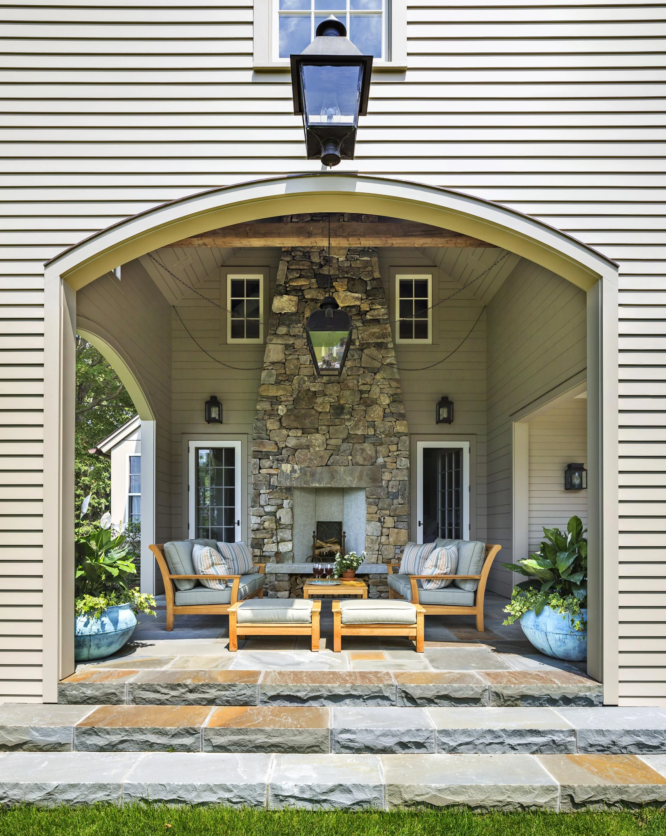 The massive fieldstone fireplace allows the covered porch to be used year-round.