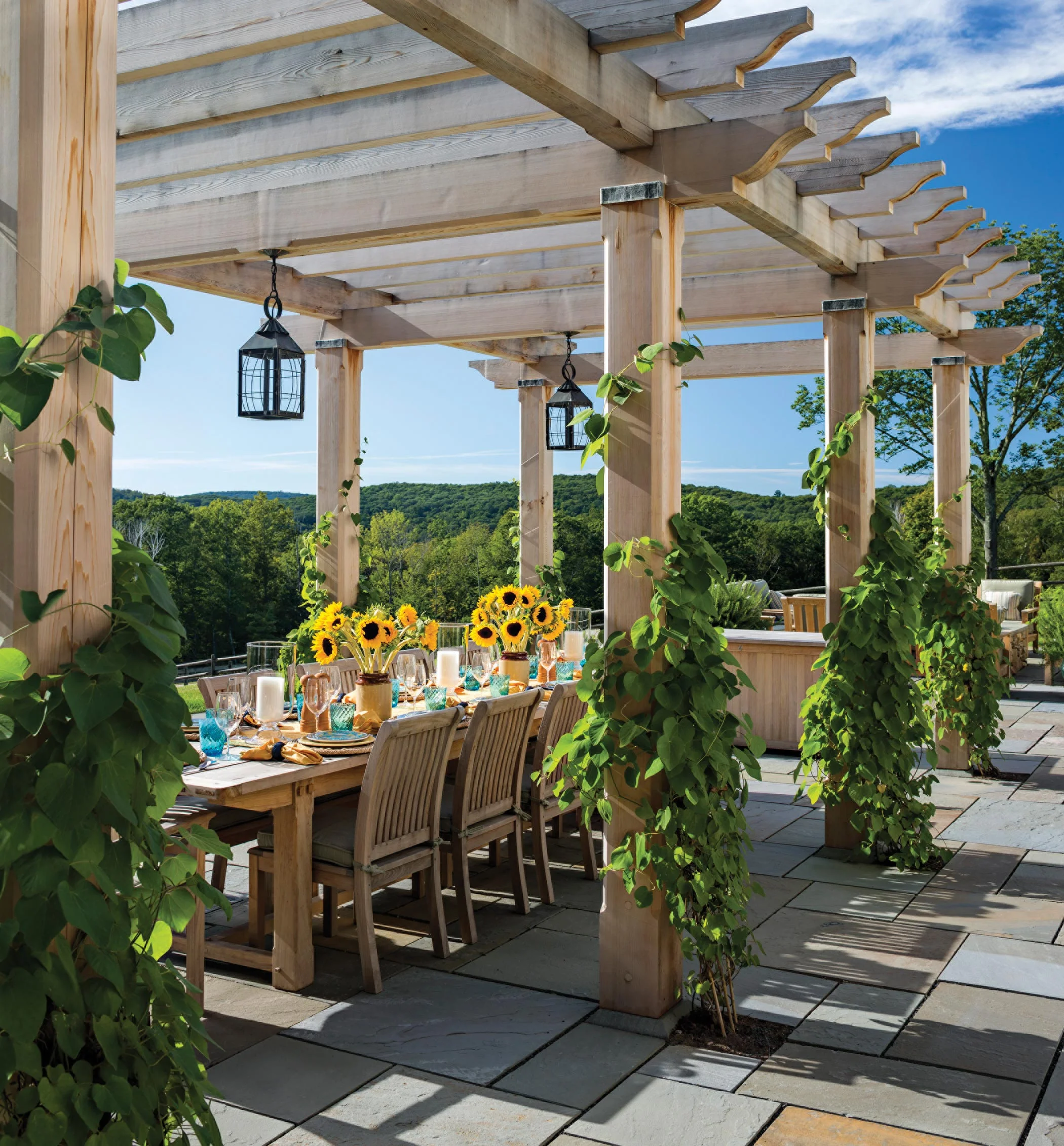 Carved in cedar, a pergola provides a shady spot for outdoor dining.