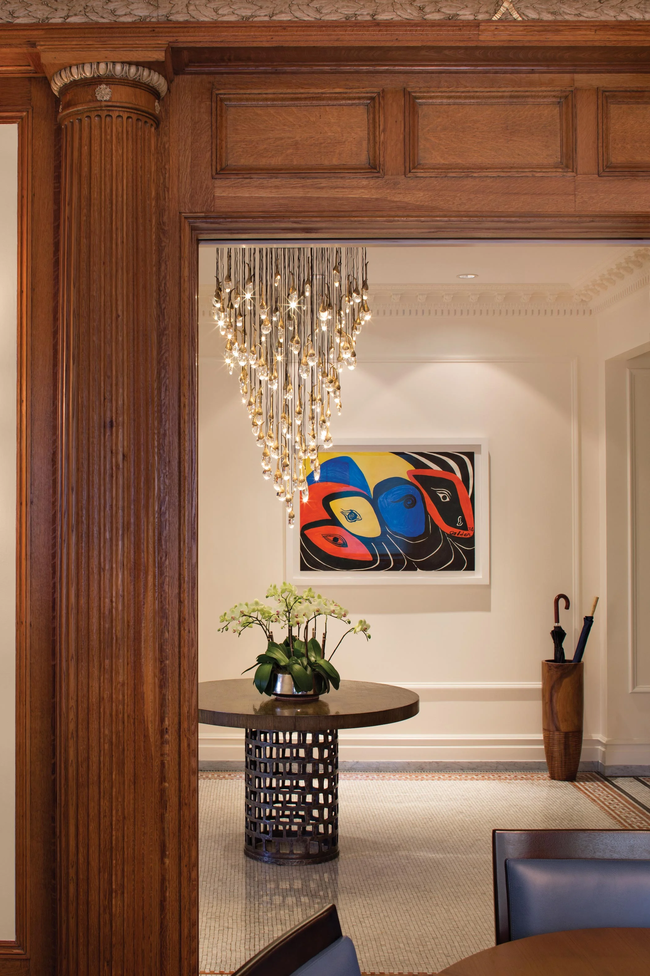 "Adjanta" by Alexander Calder is featured in the Foyer, seen from the oak-paneled Dining Room.