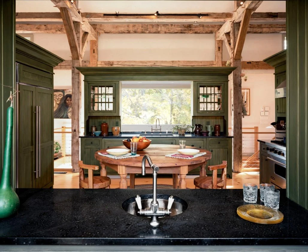 The Kitchen is defined by four millwork cabinets grouped around a custom circular island.