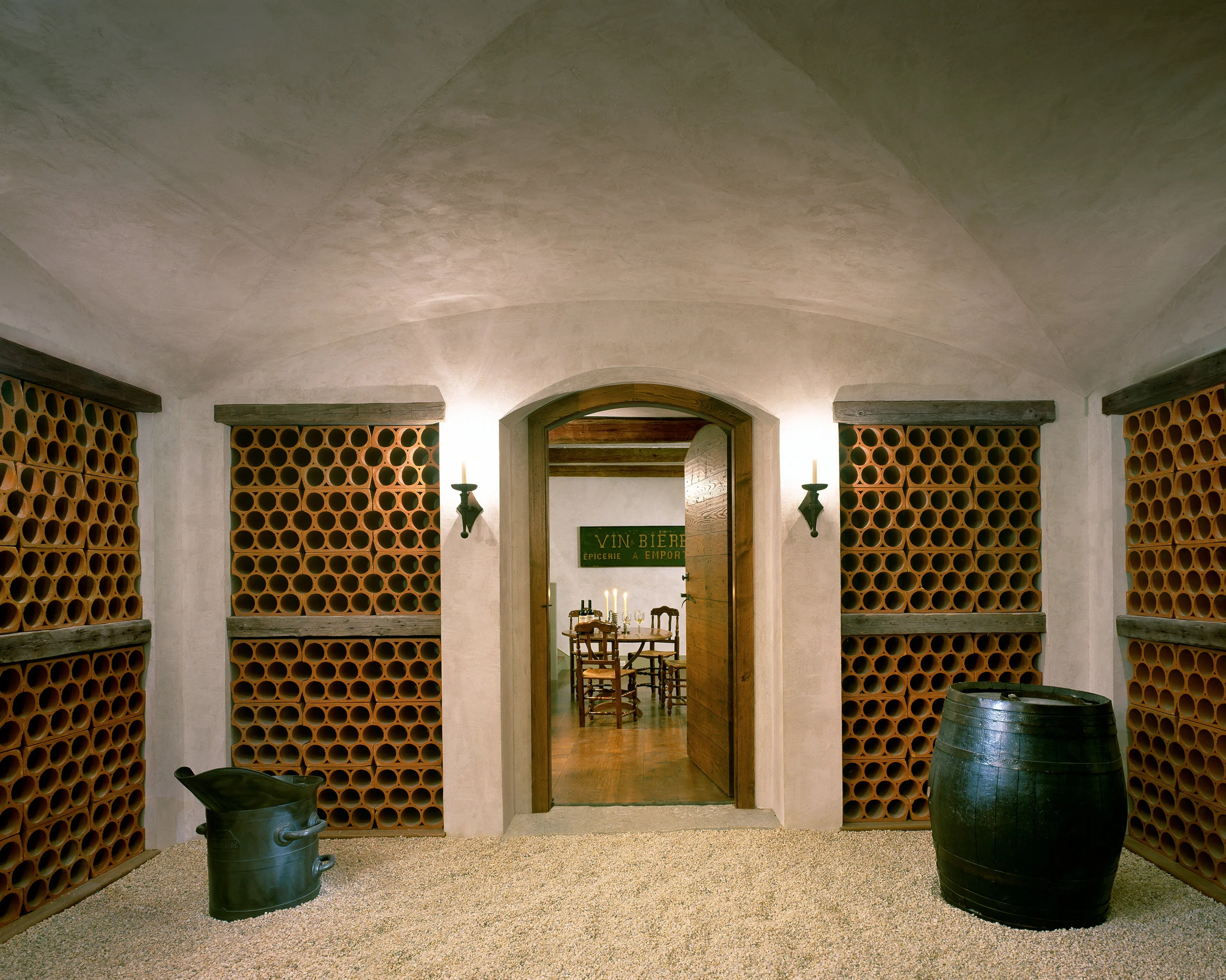 The groin-vaulted ceiling and gravel floor recall ancient French wine cellars.