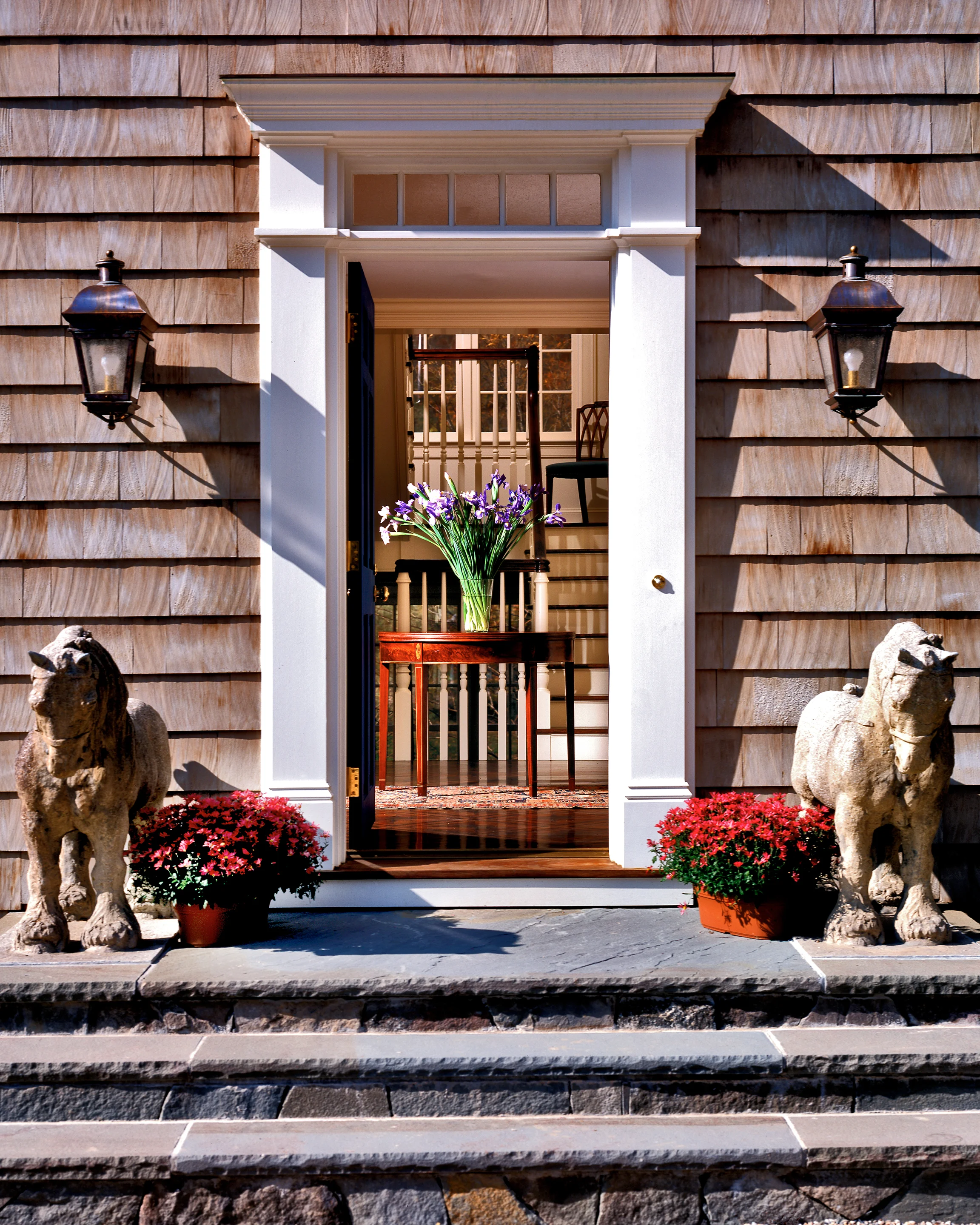 Antique carved stone horses guard the entrance to the front stair hall.