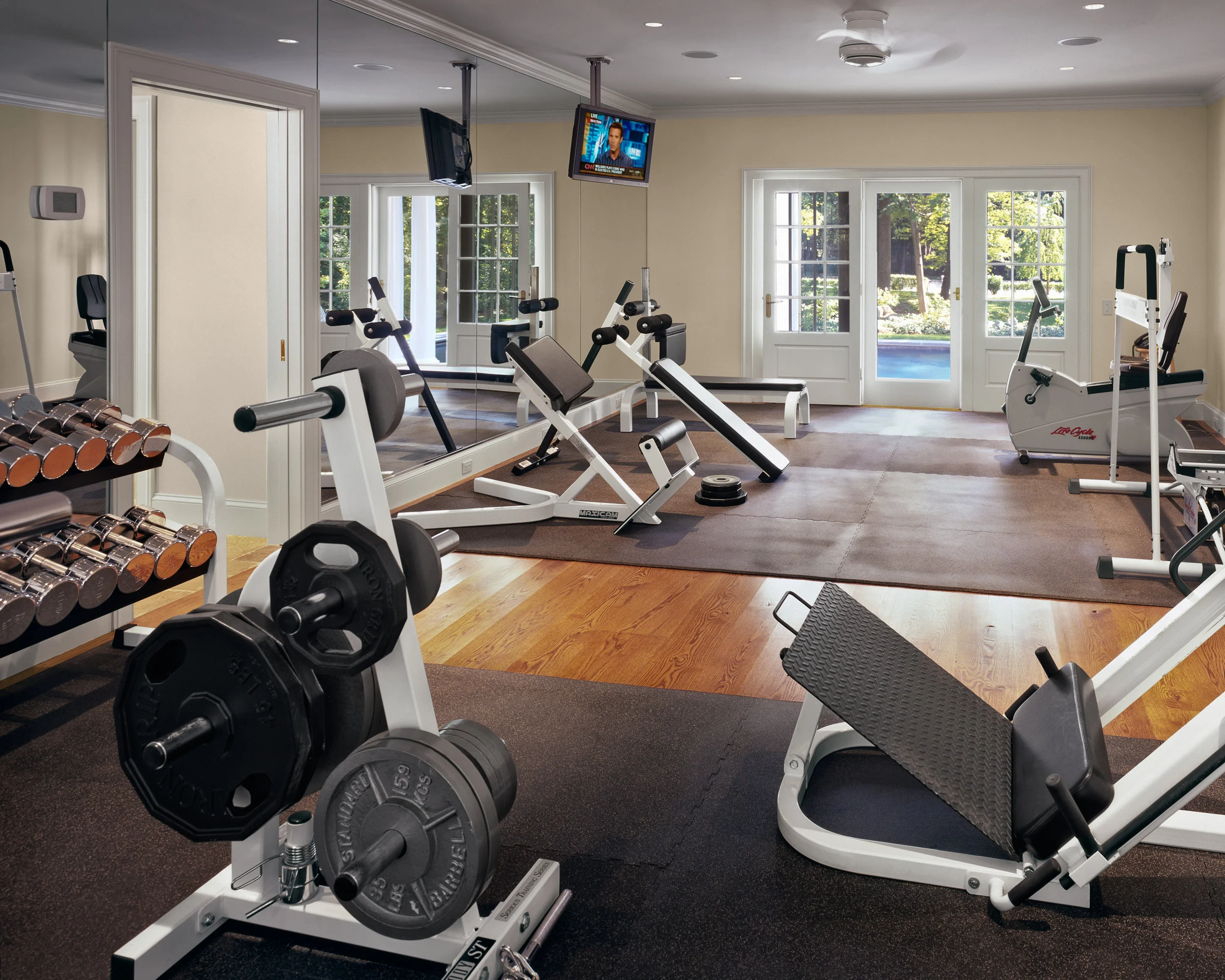 The first floor features a large family gym overlooking the pool.