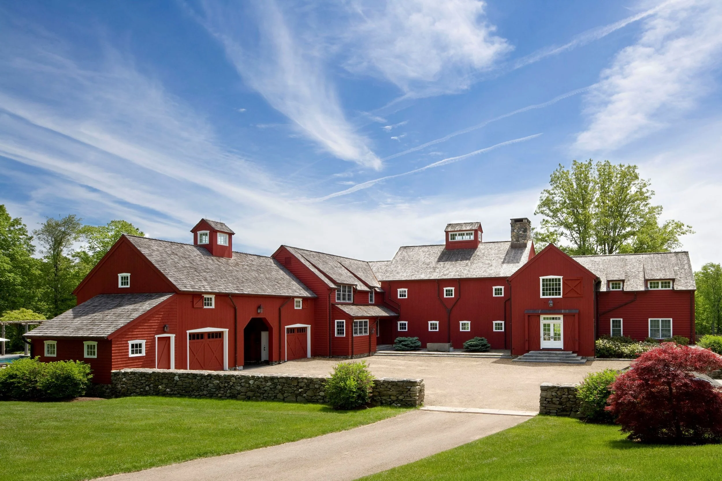 The house is designed to suggest a rambling collection of barns, clustered around a courtyard.