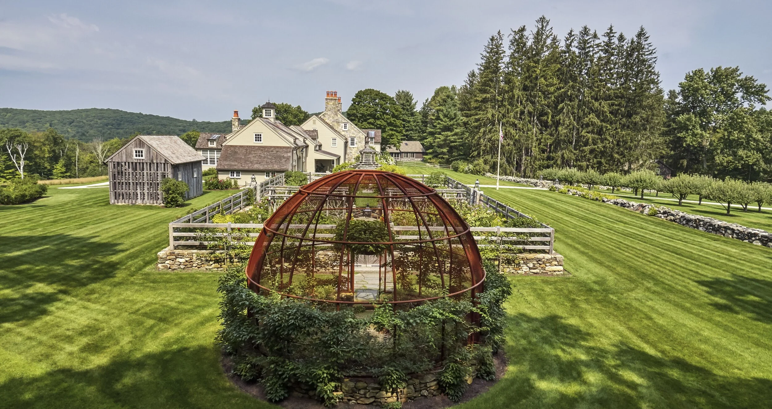 The Berry Bowl, viewed with the garden and rambling stone farmhouse in the distance.