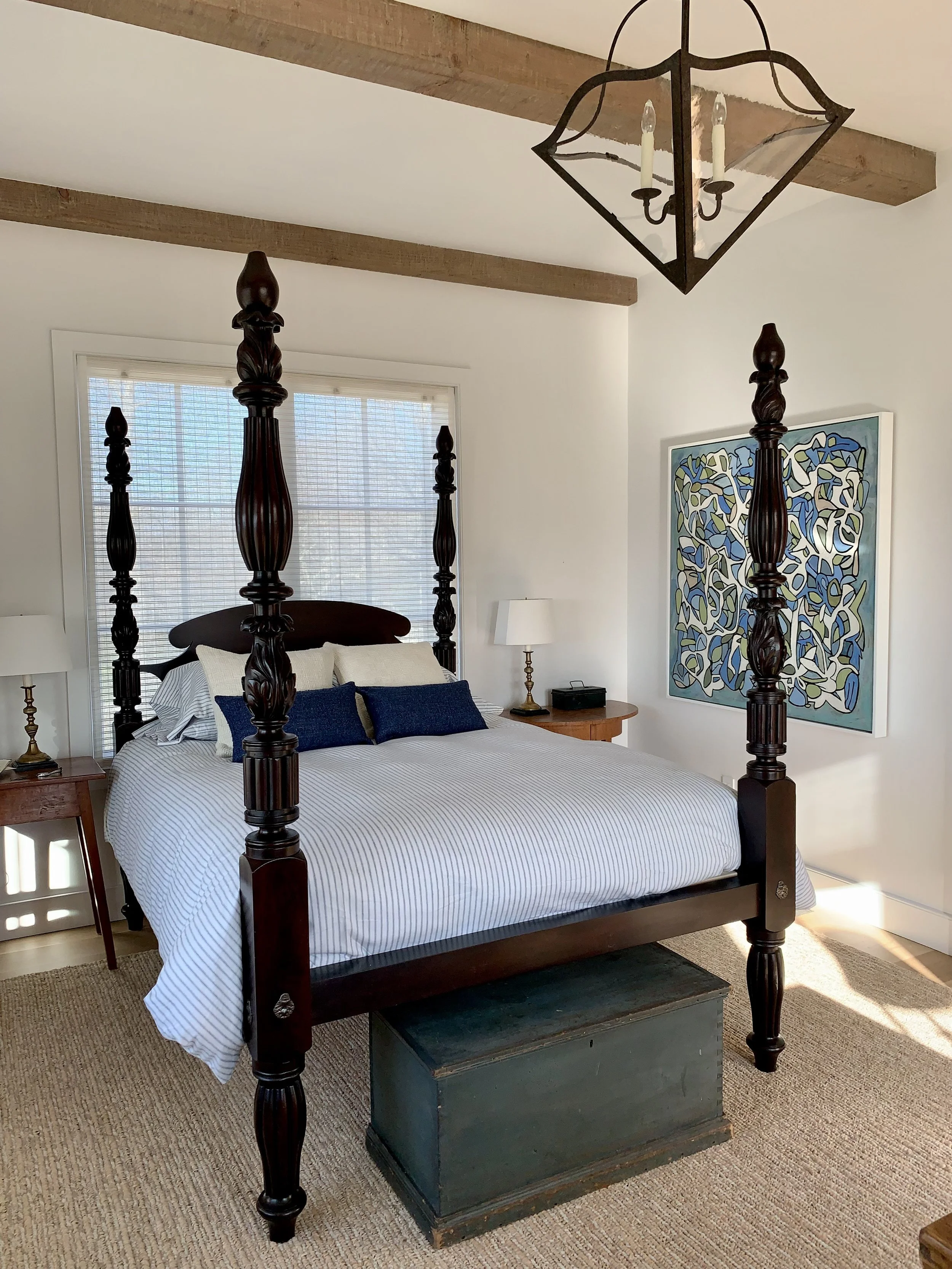 A massive 19th century ebonized mahogany poster bed anchors the bedroom.