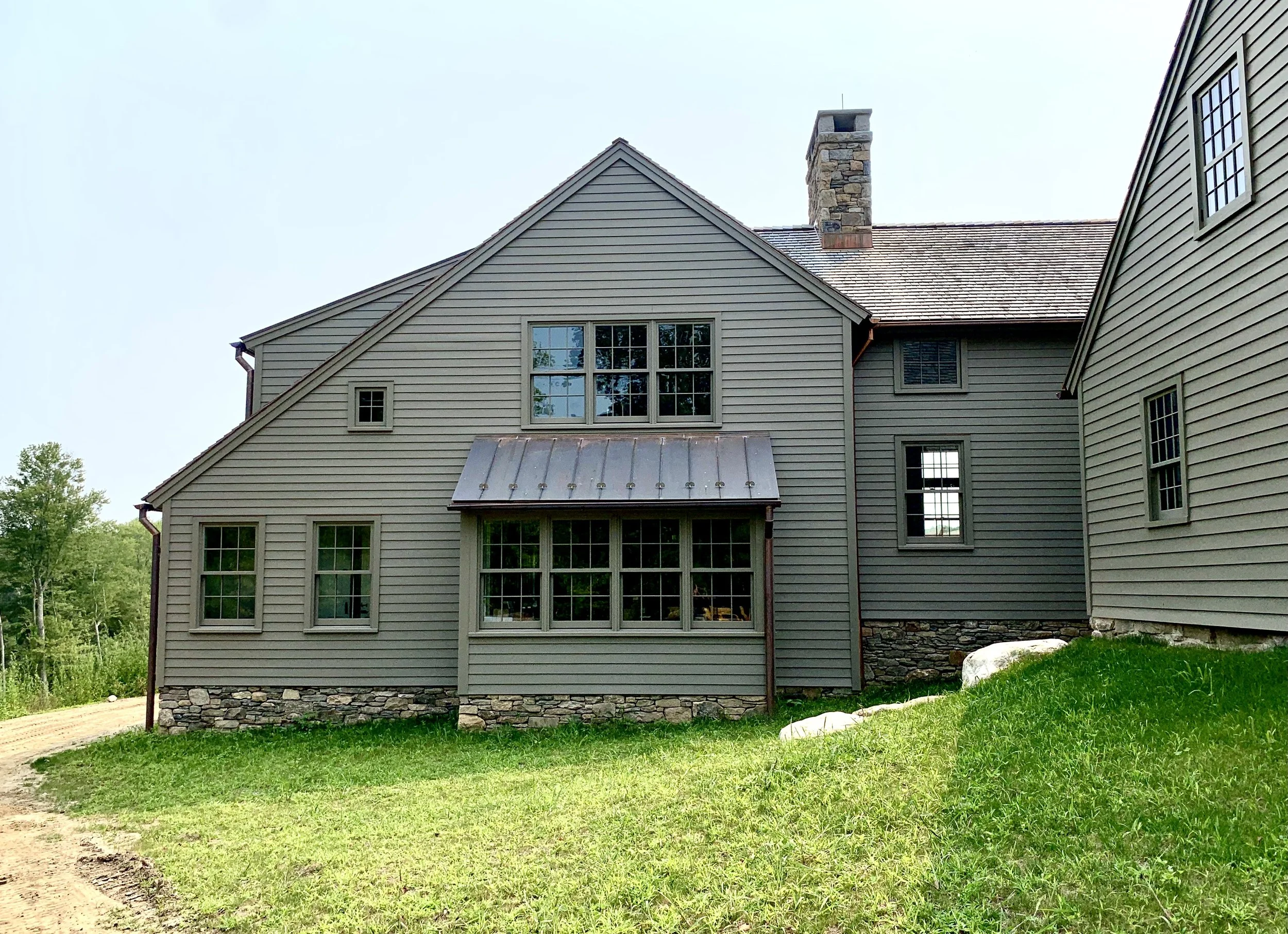 The form & scale of the new bedroom wing recalls that of the original house.