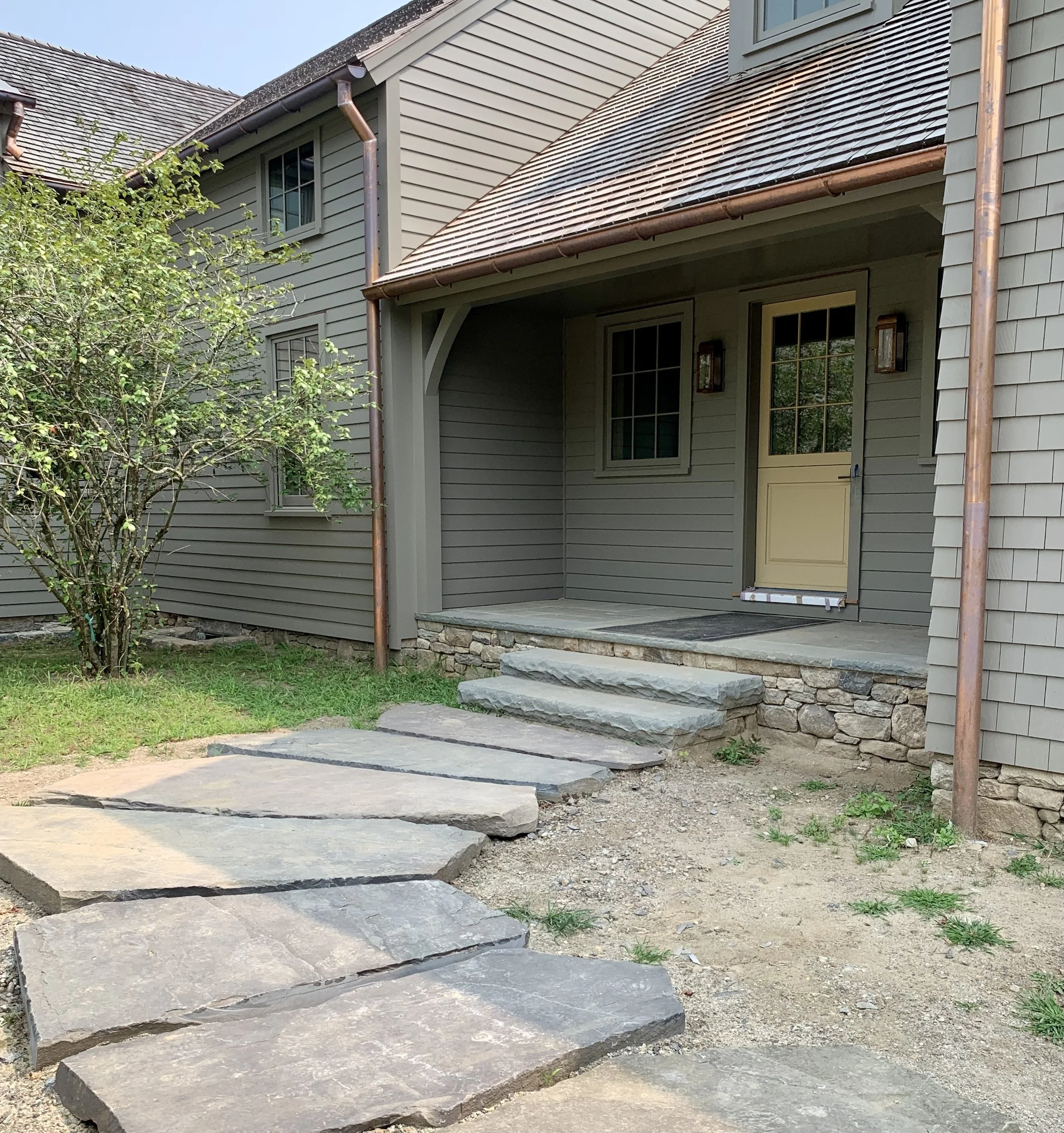 Giant antique bluestone pavers lead to the Mud Room entrance.