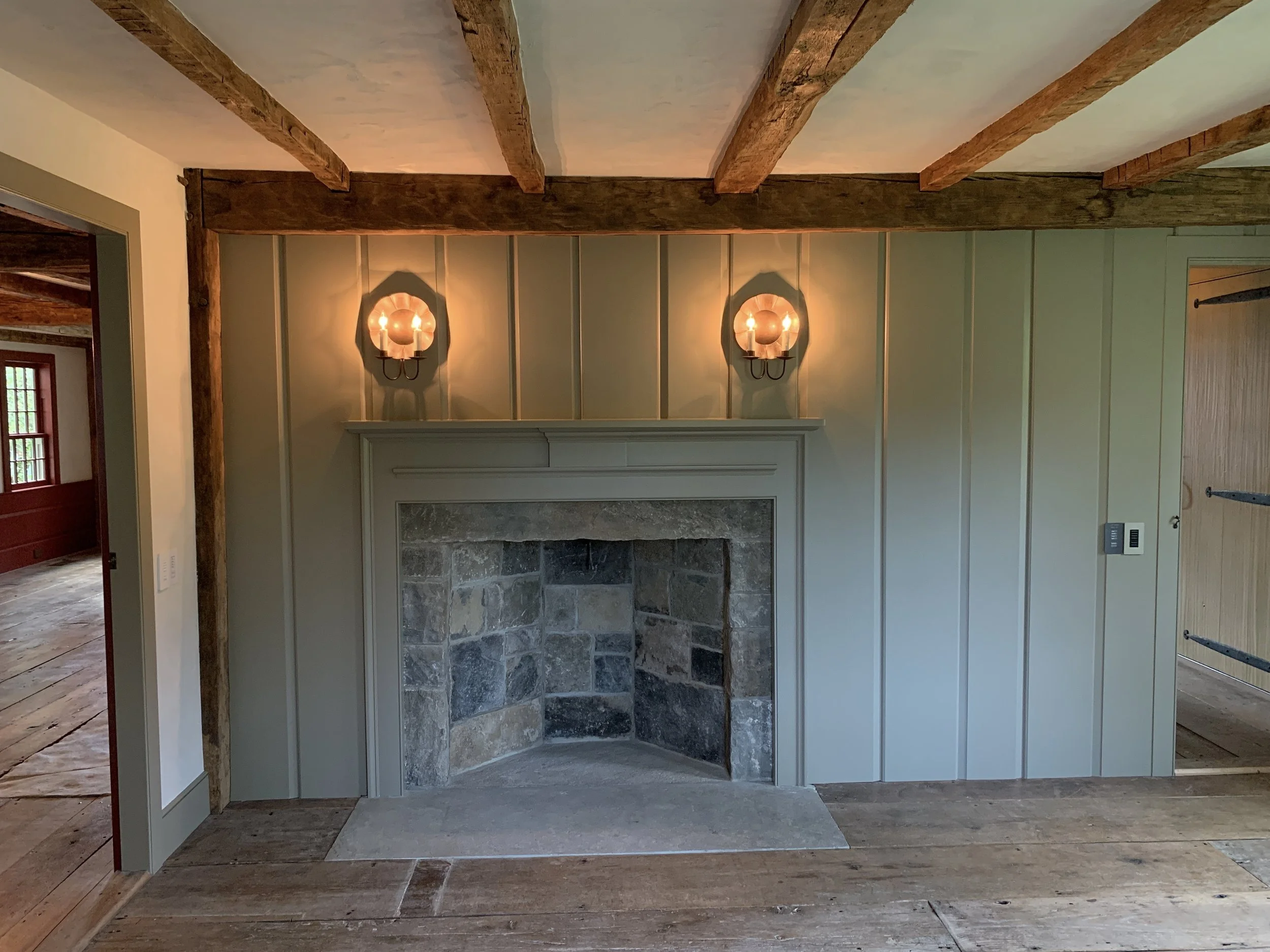  The stone fireplace and feather-edge paneling of the Study have been faithfully recreated. 