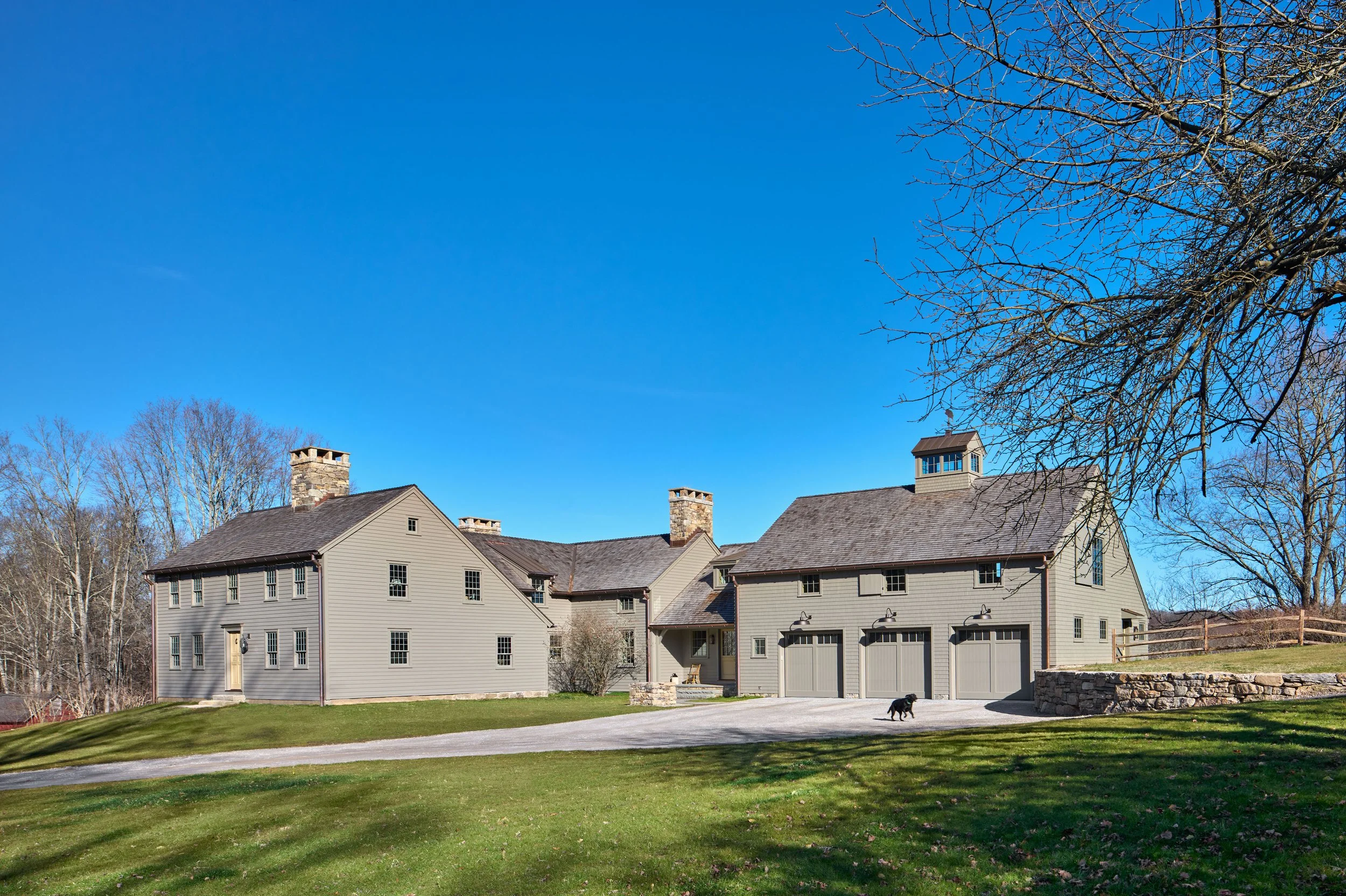  A distinctive 1770 Saltbox house is restored and greatly expanded to meet the needs of a large family.   To the right is the new carriage house wing. 
