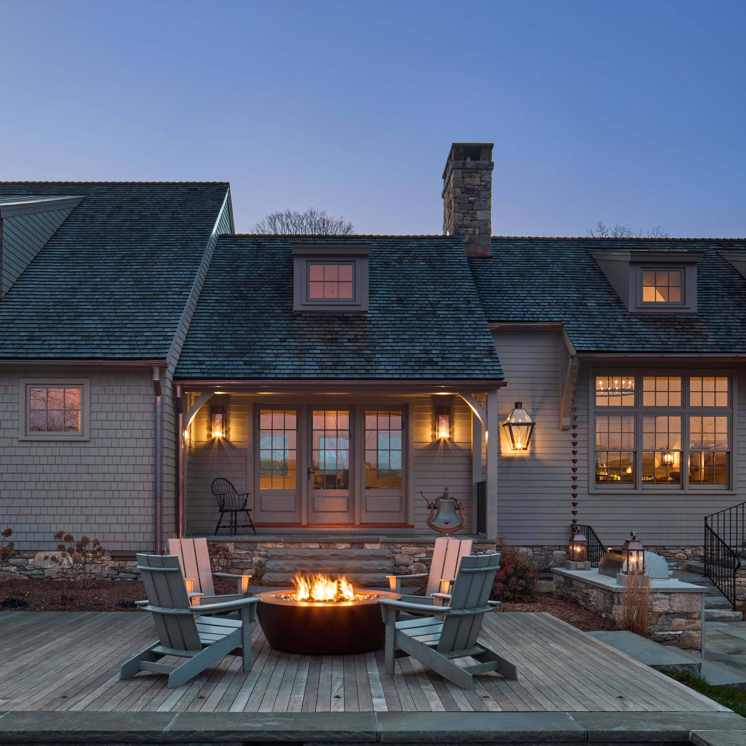  French doors from the new Mud Room are on axis with the copper fire table of the Ipe poolside deck. 