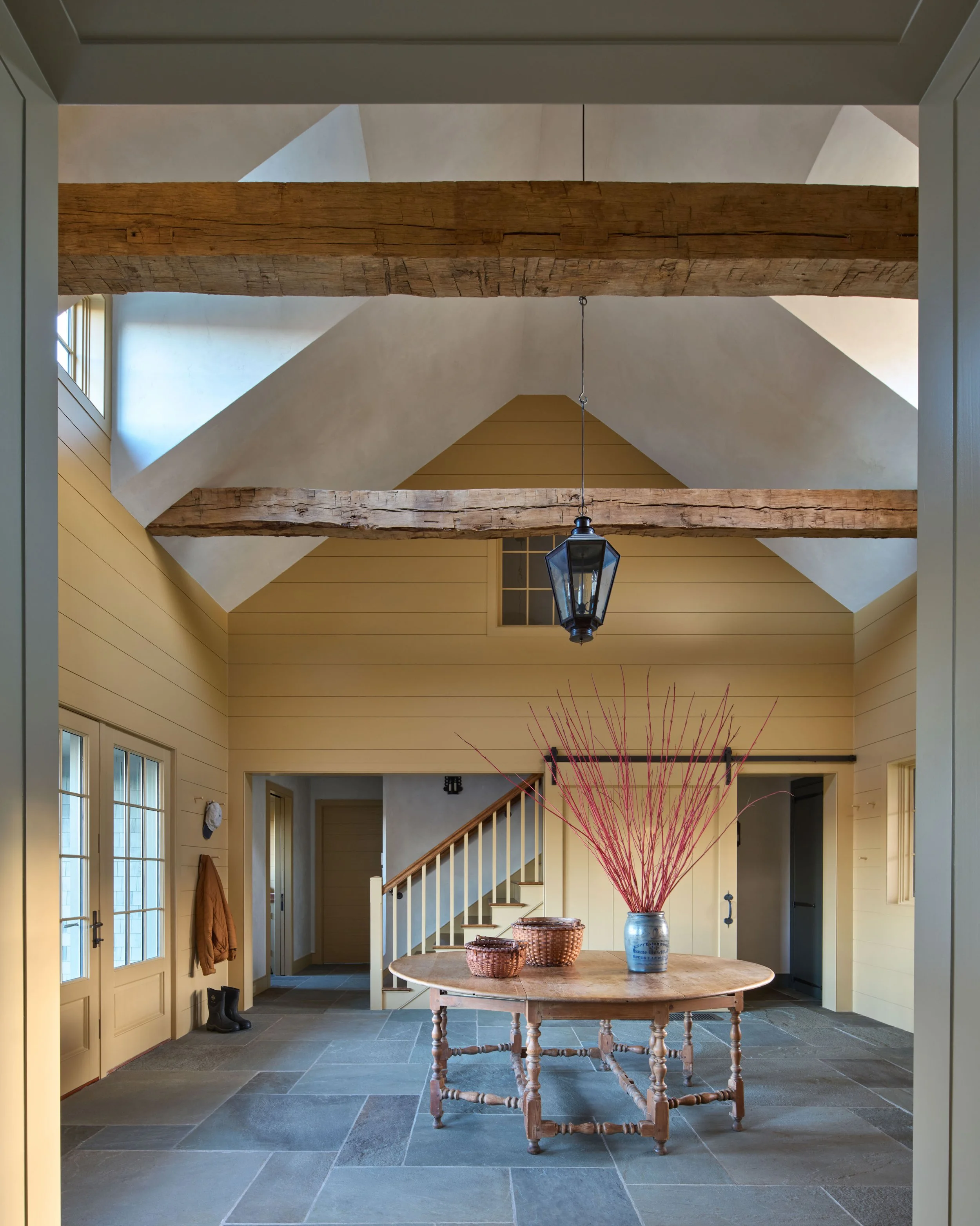  The rustic natural-cleft bluestone flooring of the exterior porches carries into the new Mud Room.&nbsp;&nbsp; The walls are clad in simple horizontal boards, typical of service spaces in 18th century New England farmhouses. 